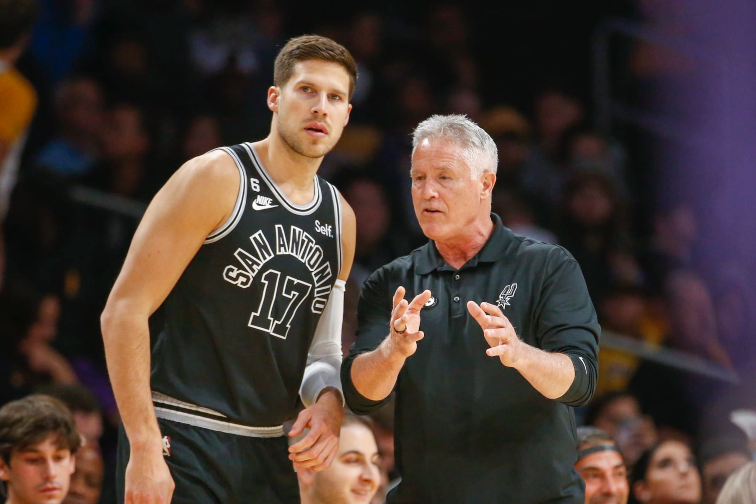 San Antonio Spurs assistant coach Brett Brown talks with forward Doug McDermott (17) during the first half of an NBA basketball game against the Los Angeles Lakers Sunday, Nov. 20, 2022 in Los Angeles. (AP Photo/Ringo H.W. Chiu)