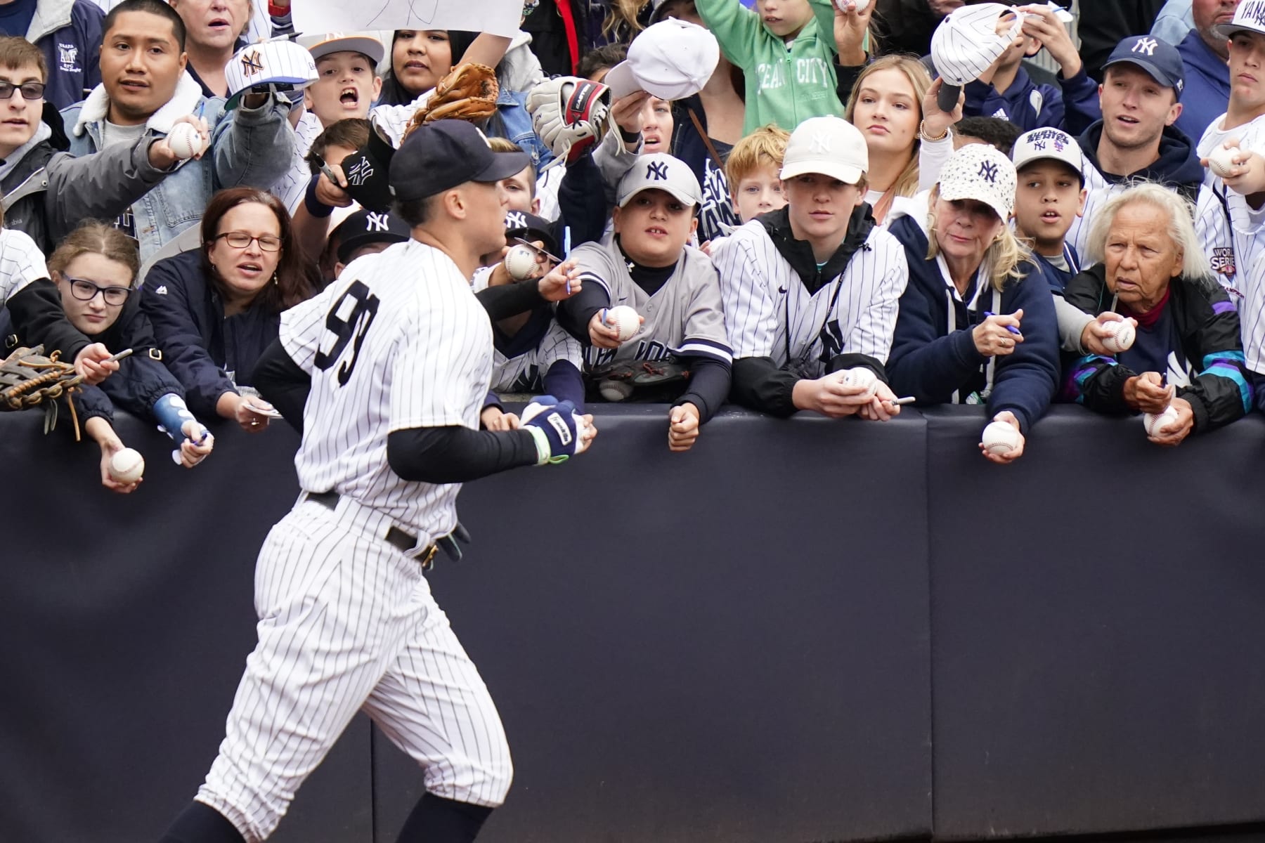 New York Yankees' Aaron Judge (99) passes fans waiting for autographs before a baseball game against the Baltimore Orioles Sunday, Oct. 2, 2022, in New York. (AP Photo/Frank Franklin II)