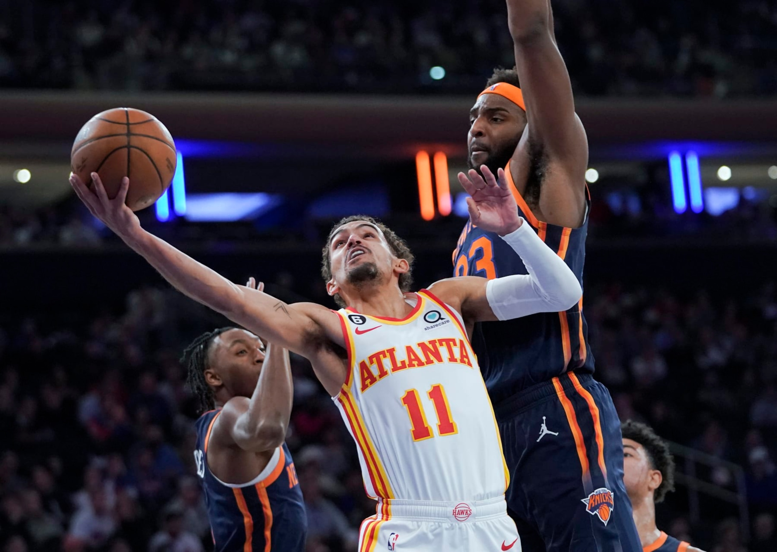 Atlanta Hawks guard Trae Young (11) goes to the basket against New York Knicks center Mitchell Robinson (23) during the first half of an NBA basketball game Wednesday, Dec. 7, 2022, at Madison Square Garden in New York. (AP Photo/Mary Altaffer)