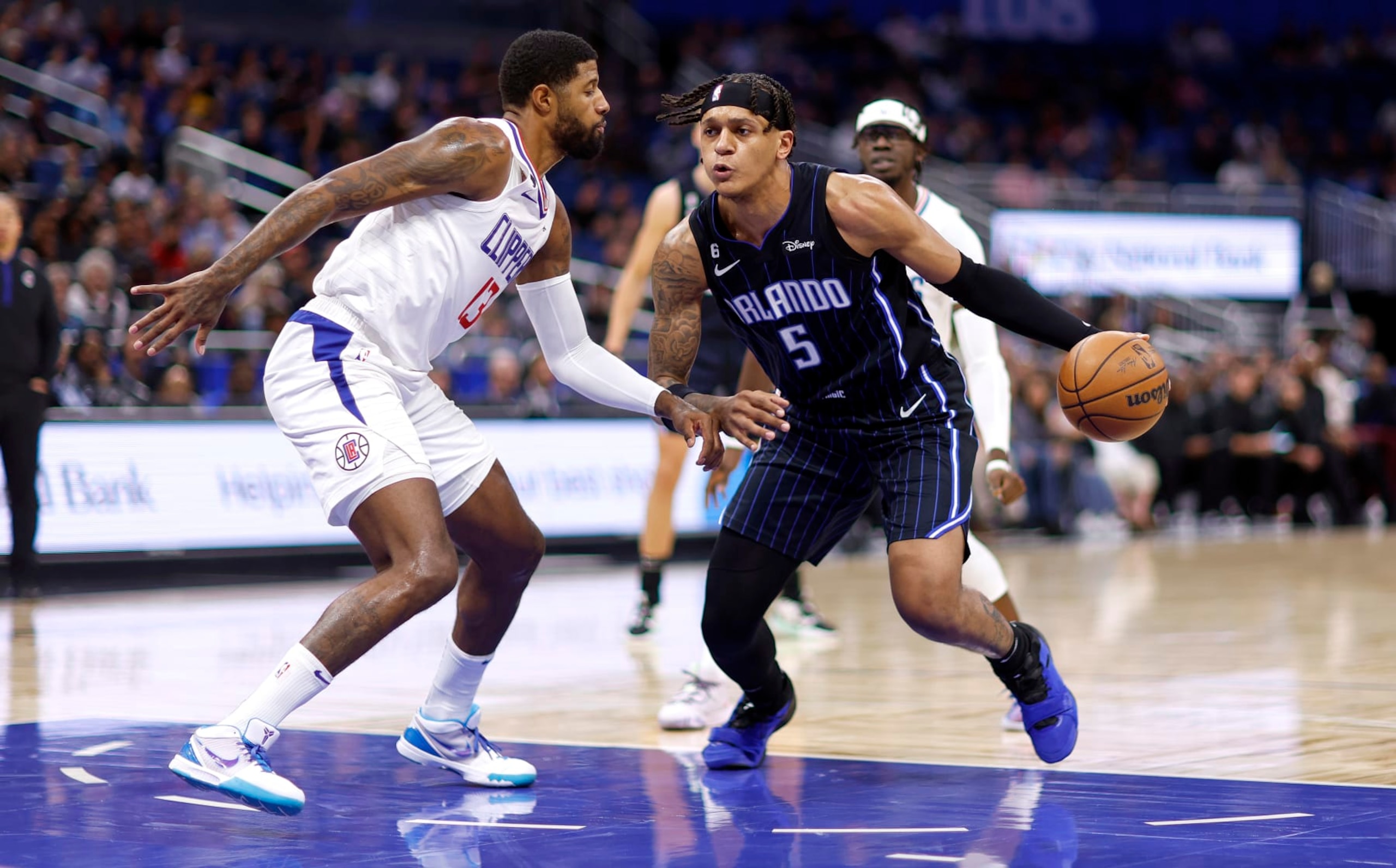ORLANDO, FLORIDA - DECEMBER 07: Paolo Banchero #5 of the Orlando Magic drives on Paul George #13 of the LA Clippers during a game at Amway Center on December 07, 2022 in Orlando, Florida. (Photo by Mike Ehrmann/Getty Images) NOTE TO USER: User expressly acknowledges and agrees that, by downloading and or using this photograph, User is consenting to the terms and conditions of the Getty Images License Agreement. ORLANDO, FLORIDA - DECEMBER 07: Paolo Banchero #5 of the Orlando Magic drives on Paul George #13 of the LA Clippers during a game at Amway Center on December 07, 2022 in Orlando, Florida. (Photo by Mike Ehrmann/Getty Images) NOTE TO USER: User expressly acknowledges and agrees that, by downloading and or using this photograph, User is consenting to the terms and conditions of the Getty Images License Agreement.