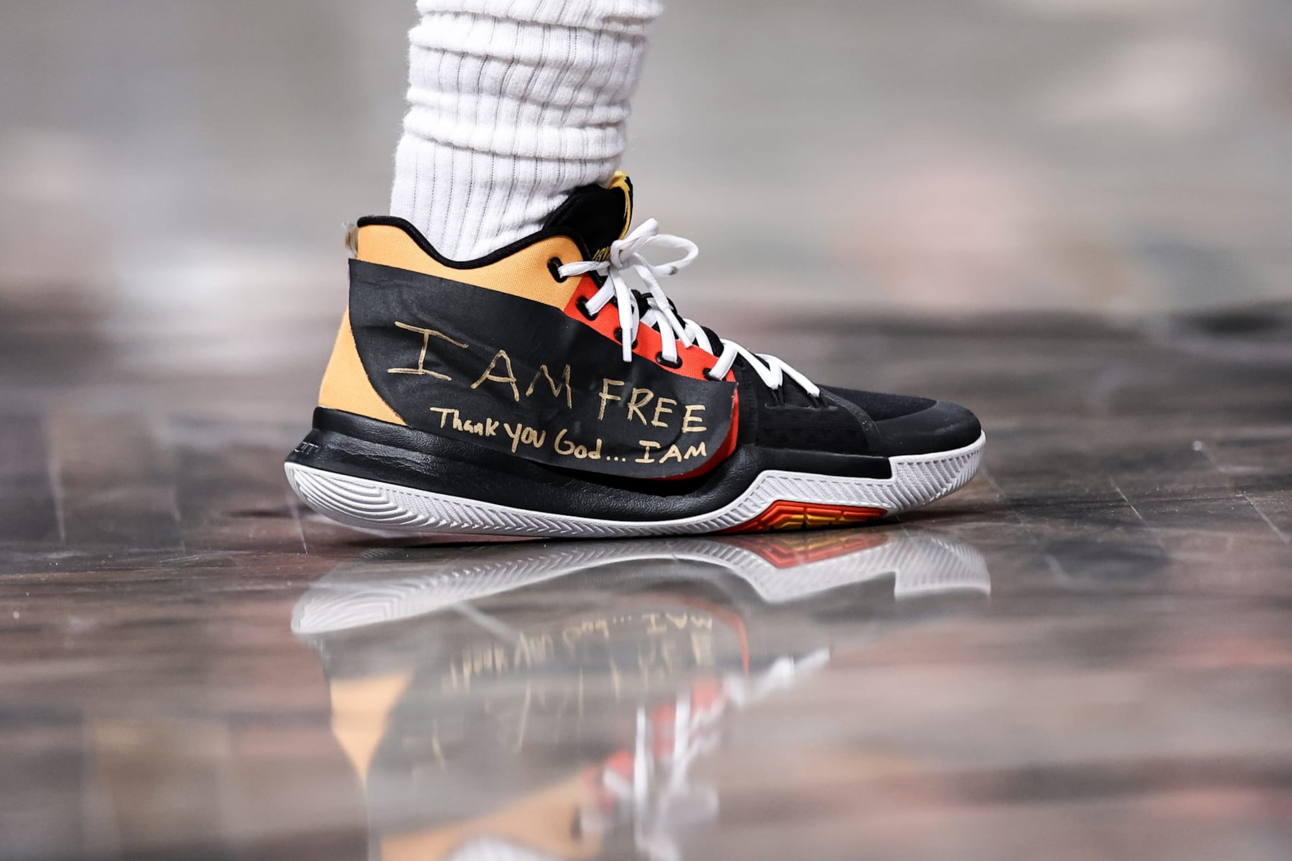 NEW YORK, NEW YORK - DECEMBER 07: A view of the taped sneakers of Kyrie Irving #11 of the Brooklyn Nets during the second quarter of the game against the Charlotte Hornets at Barclays Center on December 07, 2022 in the Brooklyn borough of New York City. NOTE TO USER: User expressly acknowledges and agrees that, by downloading and or using this photograph, User is consenting to the terms and conditions of the Getty Images License Agreement. (Photo by Dustin Satloff/Getty Images)