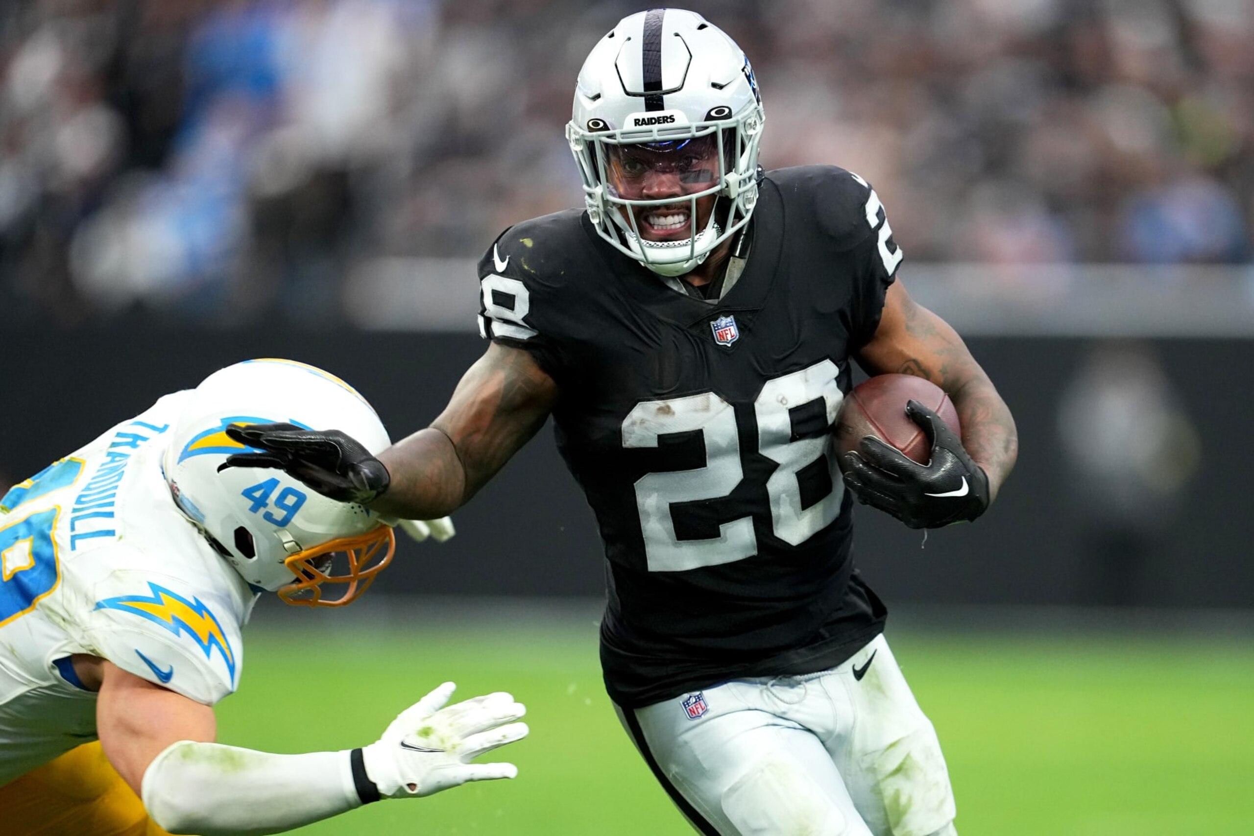 LAS VEGAS, NEVADA - DECEMBER 04: Josh Jacobs #28 of the Las Vegas Raiders runs with the ball in the second quarter of a game against the Los Angeles Chargers at Allegiant Stadium on December 04, 2022 in Las Vegas, Nevada. (Photo by Chris Unger/Getty Images) LAS VEGAS, NEVADA - DECEMBER 04: Josh Jacobs #28 of the Las Vegas Raiders runs with the ball in the second quarter of a game against the Los Angeles Chargers at Allegiant Stadium on December 04, 2022 in Las Vegas, Nevada. (Photo by Chris Unger/Getty Images)
