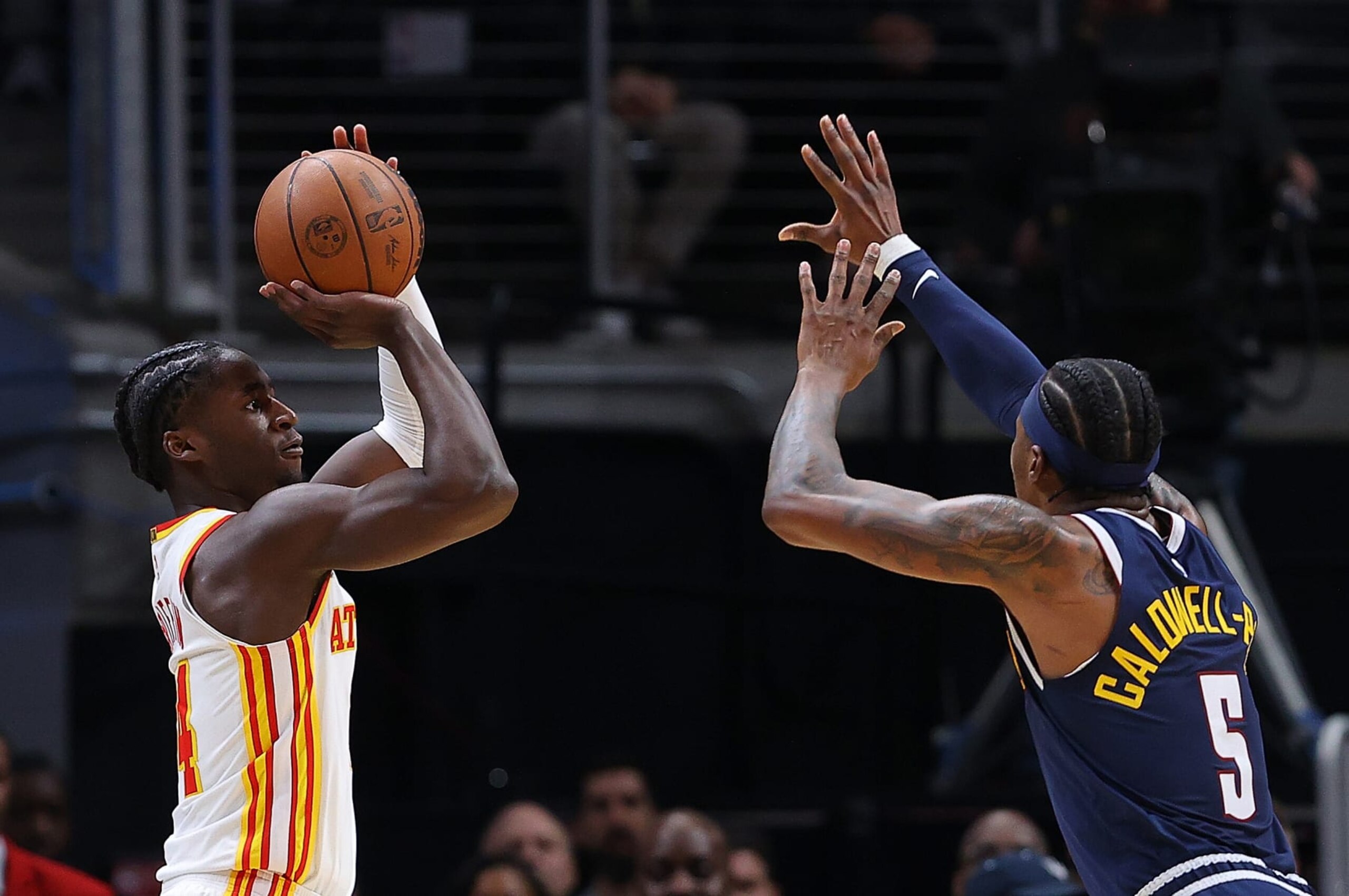 ATLANTA, GEORGIA - DECEMBER 02:  AJ Griffin #14 of the Atlanta Hawks shoots a three-point basket over Kentavious Caldwell-Pope #5 of the Denver Nuggets during the first half at State Farm Arena on December 02, 2022 in Atlanta, Georgia.  NOTE TO USER: User expressly acknowledges and agrees that, by downloading and or using this photograph, User is consenting to the terms and conditions of the Getty Images License Agreement.  (Photo by Kevin C. Cox/Getty Images)