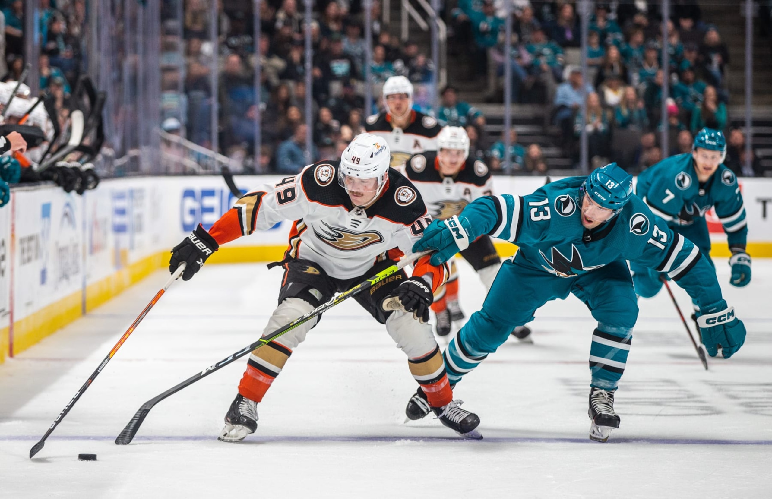 Anaheim Ducks left wing Max Jones (left) competes for the puck with San Jose Sharks winger Nick Bonino.