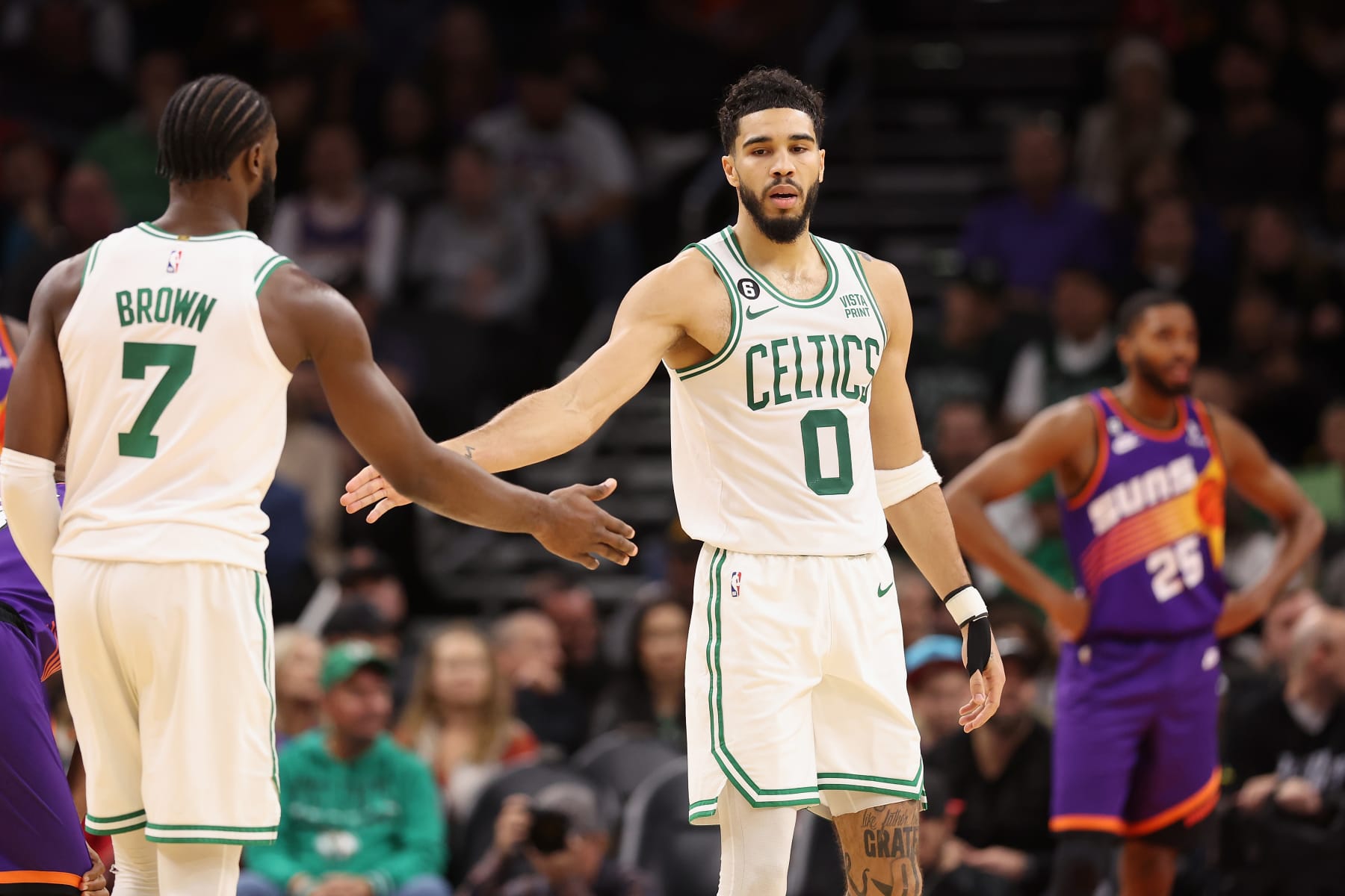 PHOENIX, ARIZONA - DECEMBER 07: Jayson Tatum #0 of the Boston Celtics high fives Jaylen Brown #7 after scoring against the Phoenix Suns during the second half of the NBA game at Footprint Center on December 07, 2022 in Phoenix, Arizona. NOTE TO USER: User expressly acknowledges and agrees that, by downloading and or using this photograph, User is consenting to the terms and conditions of the Getty Images License Agreement. (Photo by Christian Petersen/Getty Images)