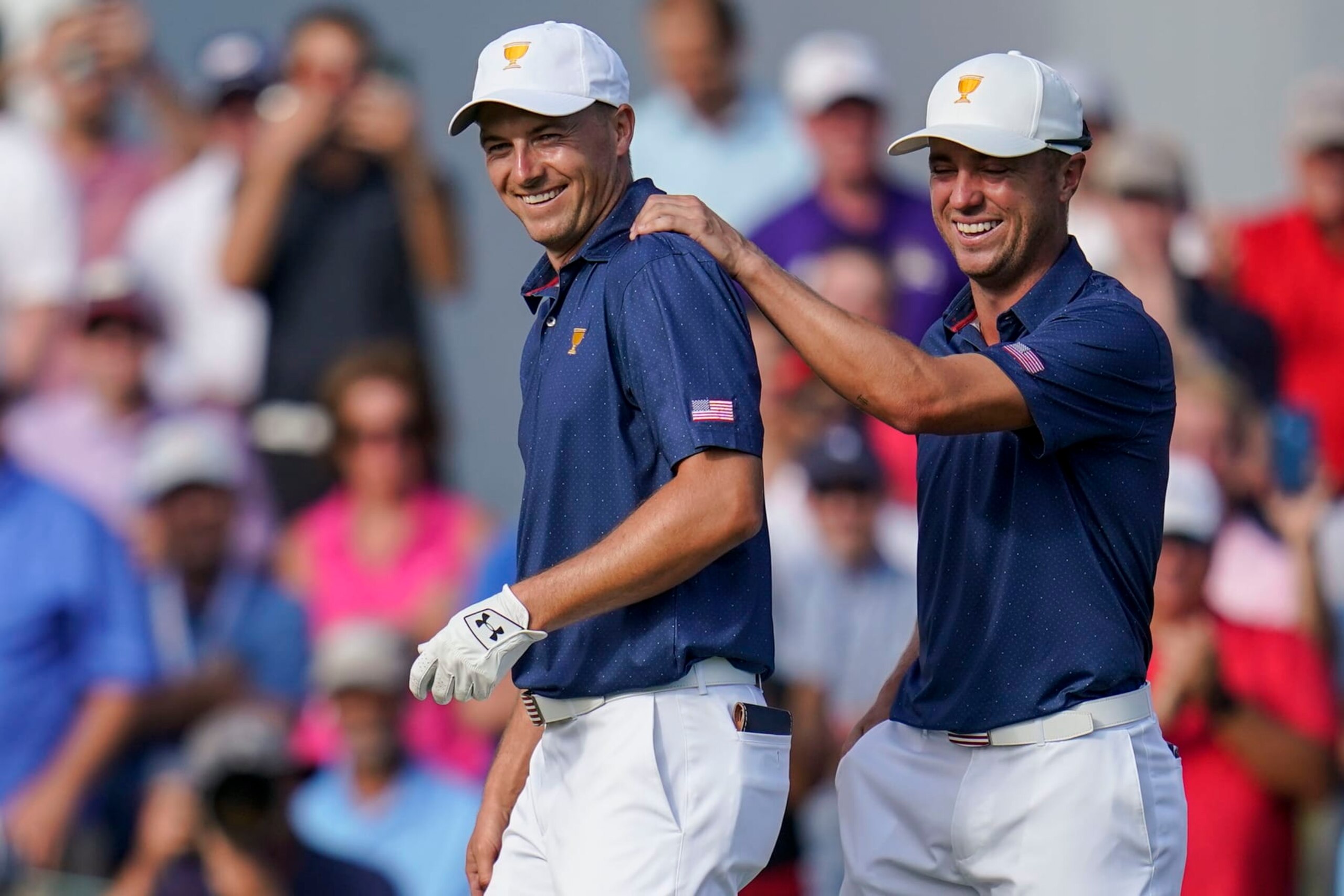 Jordan Spieth, left, and Justin Thomas celebrate winning the match on the 15th hole during their fourball match at the Presidents Cup golf tournament at the Quail Hollow Club, Saturday, Sept. 24, 2022, in Charlotte, N.C. (AP Photo/Julio Cortez)