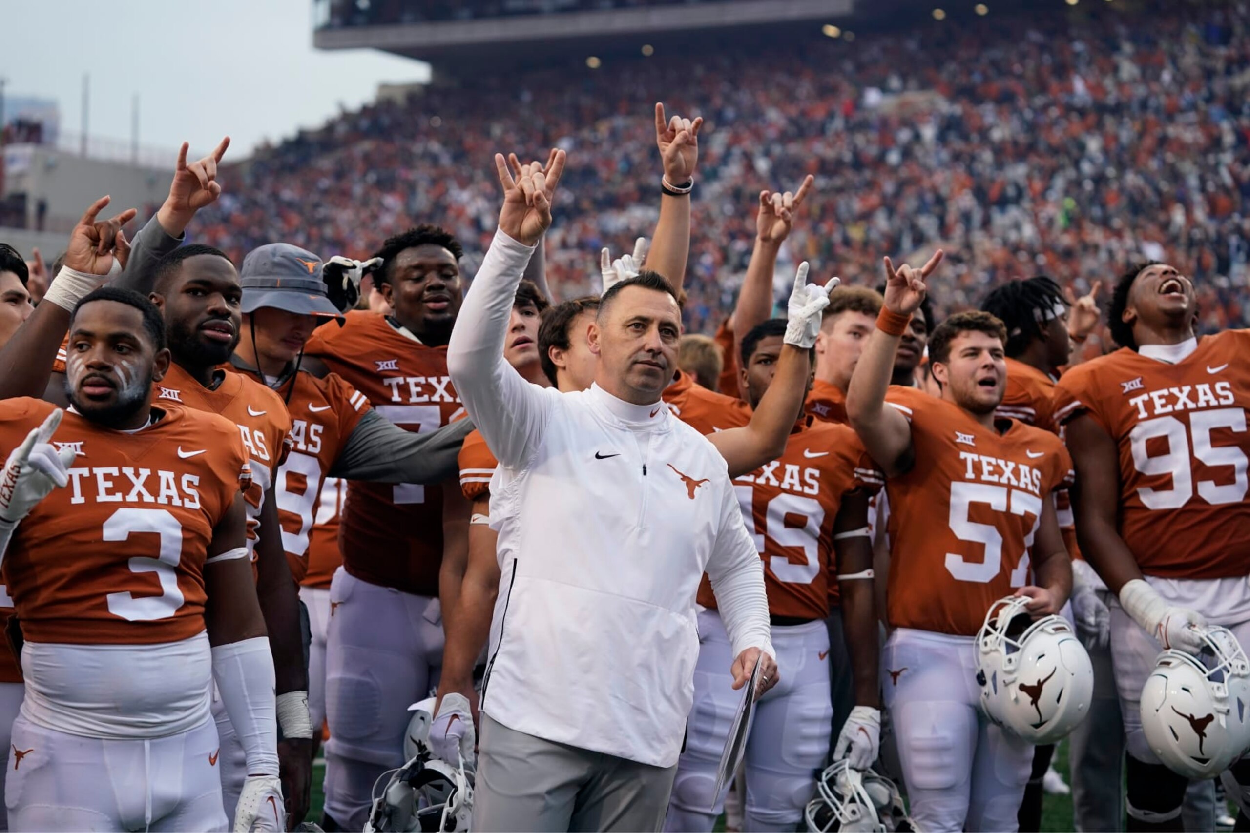 Texas head coach Steve Sarkisian, center, joins his team for the school song following their win over Baylor in an NCAA college football game in Austin, Texas, Friday, Nov. 25, 2022. (AP Photo/Eric Gay)