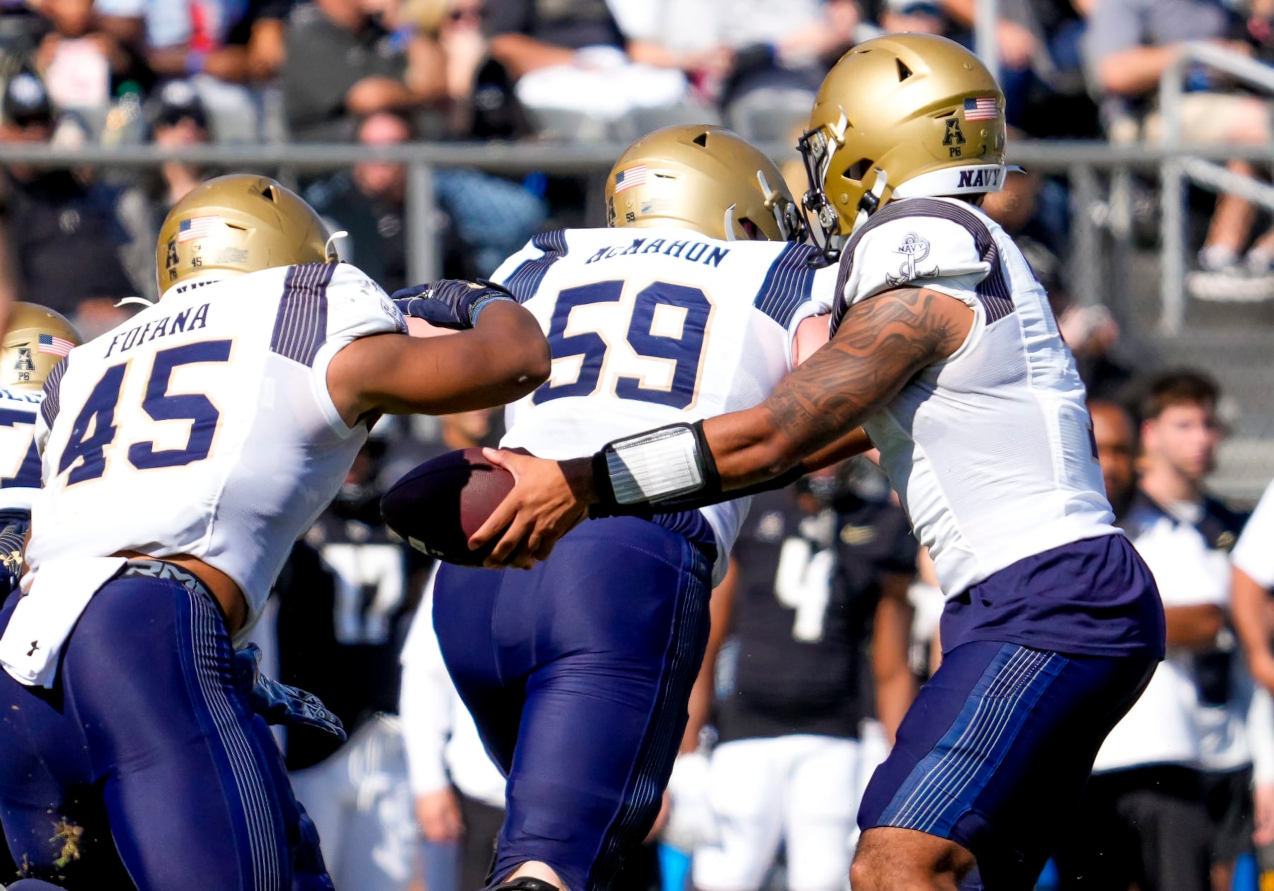 ORLANDO, FL - NOVEMBER 19: Navy Midshipmen quarterback Xavier Arline (7) hands off to Navy Midshipmen fullback Daba Fofana (45)during the football game between the UCF Knights and the Navy Midshipmen on November 19th, 2022 at FBC Mortgage Stadium in Orlando, FL. (Photo by Andrew Bershaw/Icon Sportswire via Getty Images)
