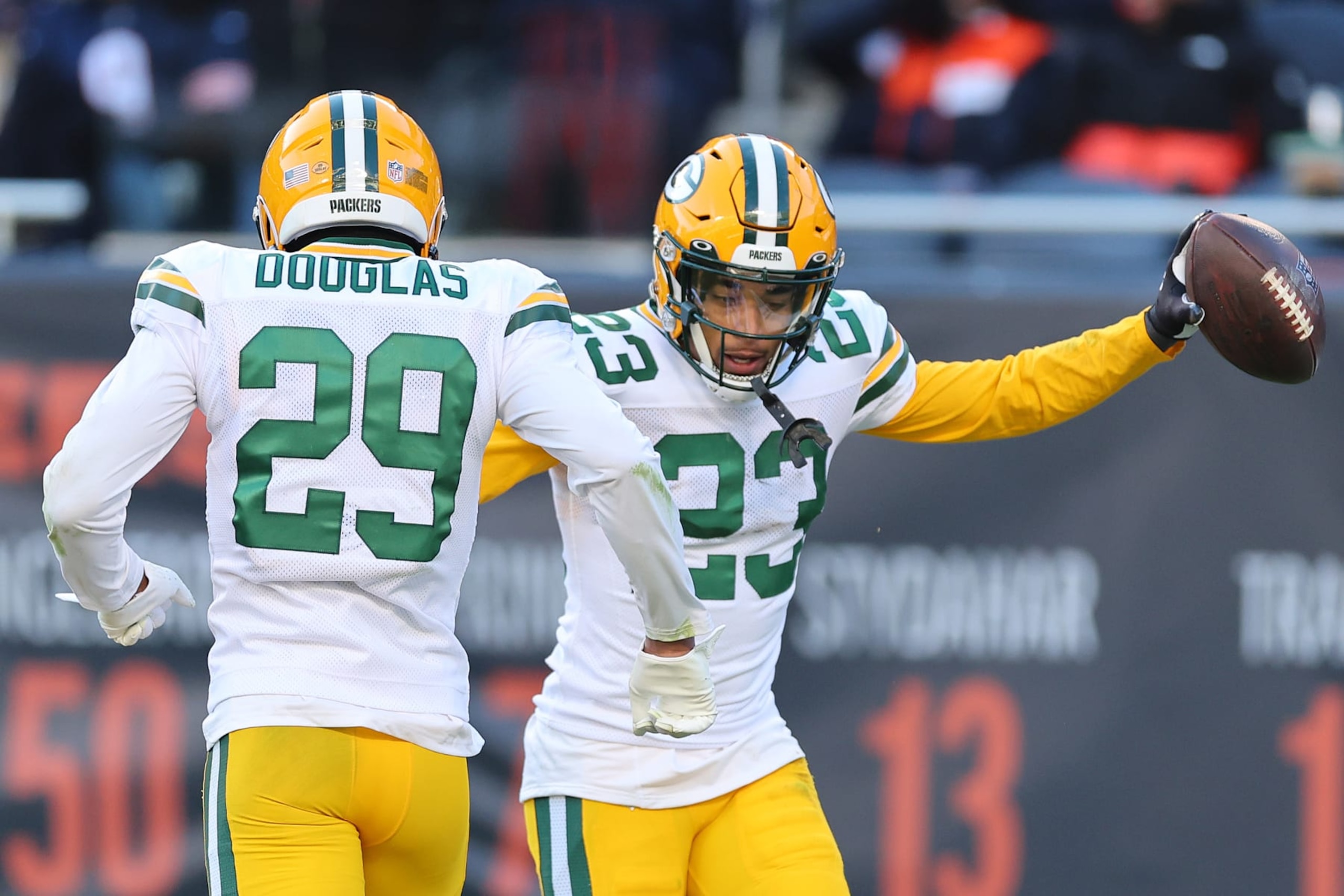 CHICAGO, ILLINOIS - DECEMBER 04: Jaire Alexander #23 of the Green Bay Packers celebrates an interception with Rasul Douglas #29 against the Chicago Bears during the fourth quarter at Soldier Field on December 04, 2022 in Chicago, Illinois. (Photo by Michael Reaves/Getty Images)