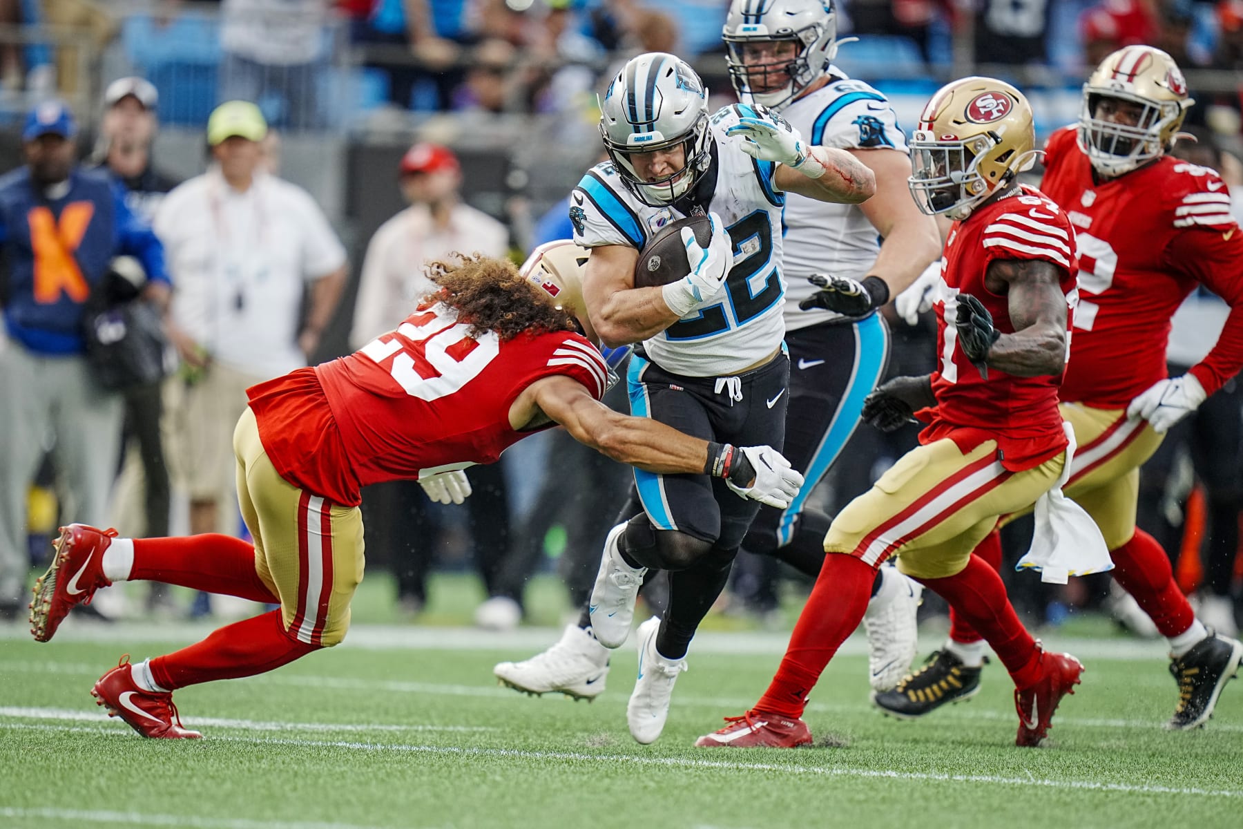 Carolina Panthers running back Christian McCaffrey (22) attempts to run past San Francisco 49ers safety Talanoa Hufanga (29) and safety Tashaun Gipson Sr., right, during an NFL football game on Sunday, Oct. 09, 2022, in Charlotte, N.C. (AP Photo/Rusty Jones)