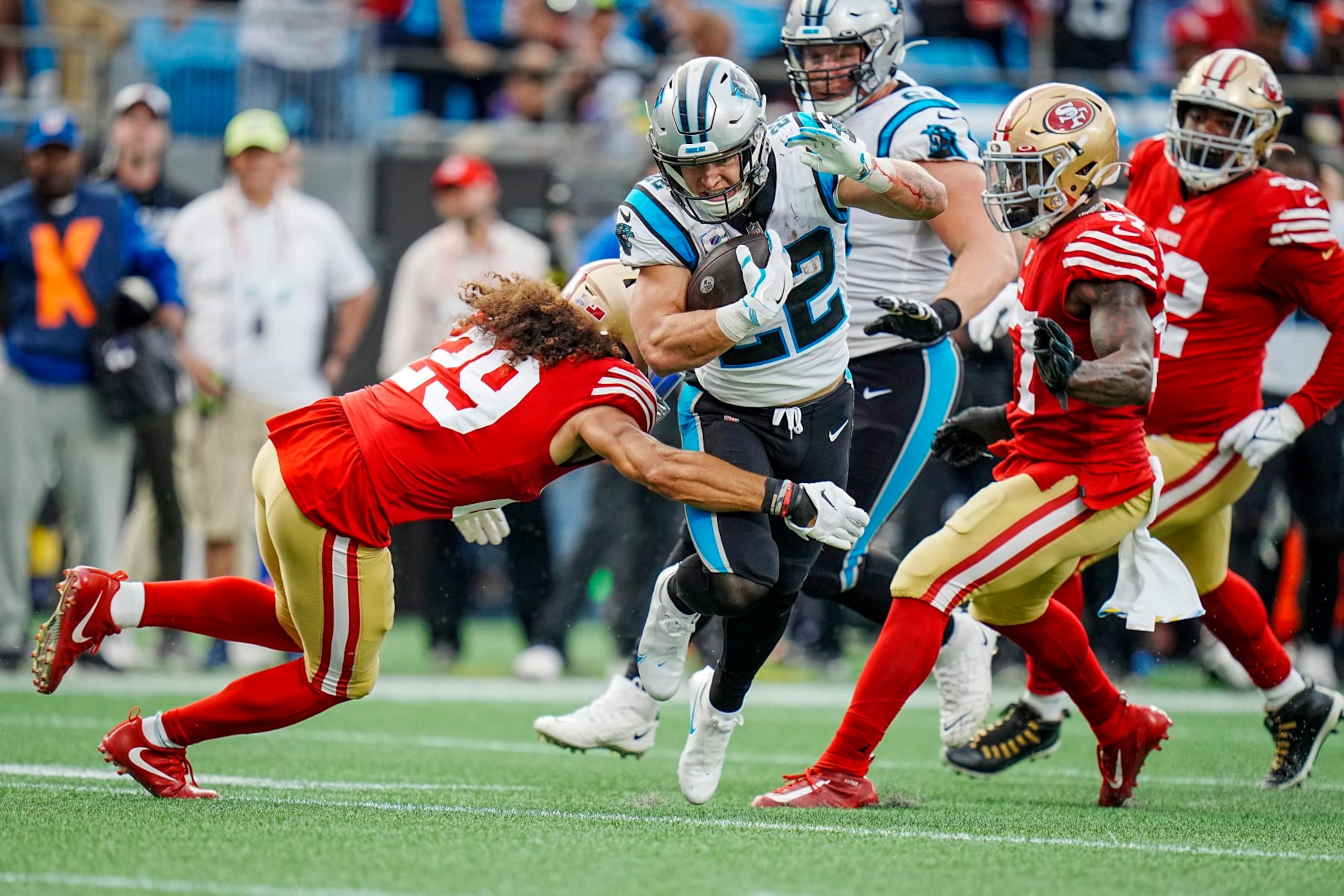 Carolina Panthers running back Christian McCaffrey (22) attempts to run past San Francisco 49ers safety Talanoa Hufanga (29) and safety Tashaun Gipson Sr., right, during an NFL football game on Sunday, Oct. 09, 2022, in Charlotte, N.C. (AP Photo/Rusty Jones) Carolina Panthers running back Christian McCaffrey (22) attempts to run past San Francisco 49ers safety Talanoa Hufanga (29) and safety Tashaun Gipson Sr., right, during an NFL football game on Sunday, Oct. 09, 2022, in Charlotte, N.C. (AP Photo/Rusty Jones)