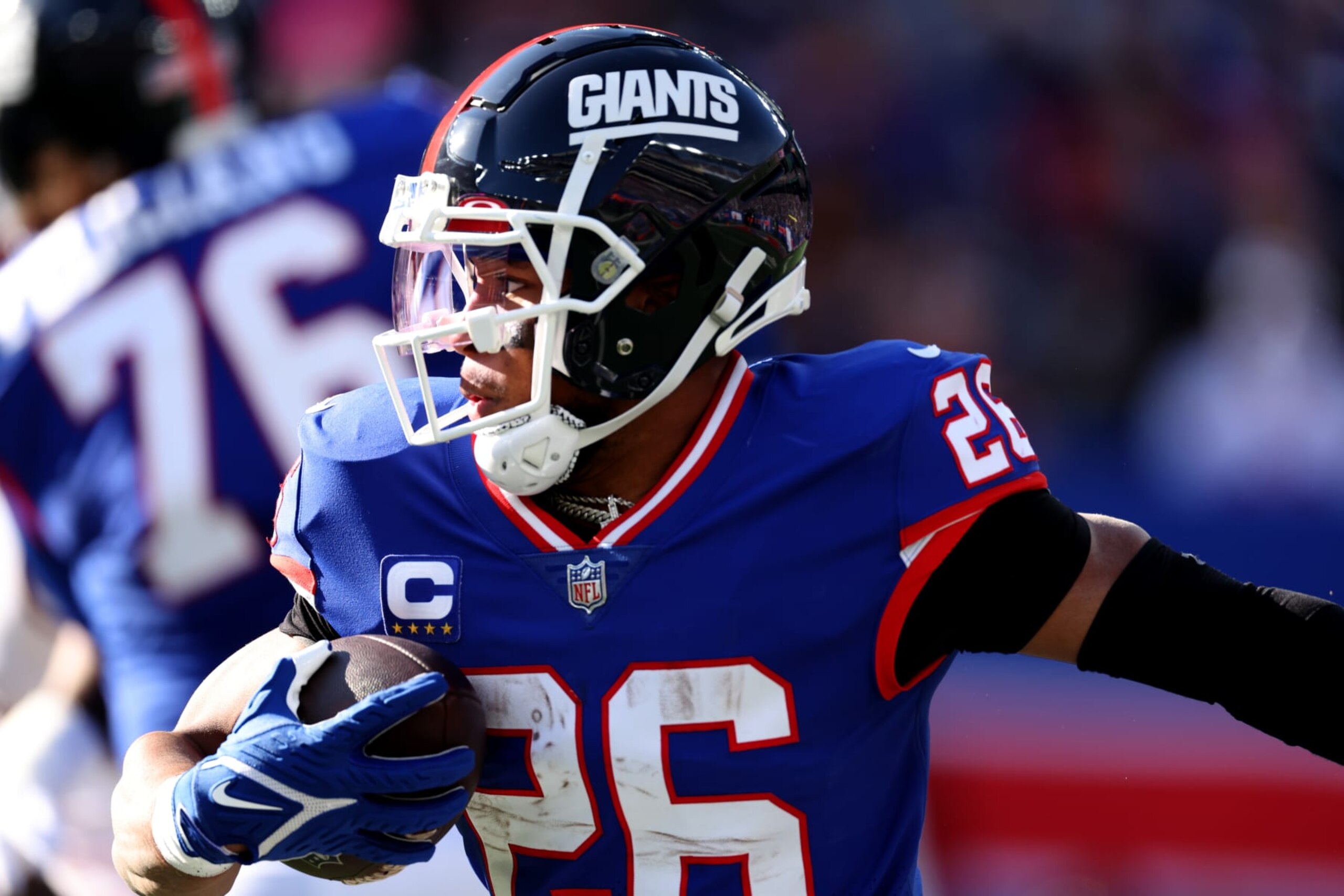 EAST RUTHERFORD, NEW JERSEY - DECEMBER 04: Saquon Barkley #26 of the New York Giants runs with the ball in the first half of a game against the Washington Commanders at MetLife Stadium on December 04, 2022 in East Rutherford, New Jersey. (Photo by Al Bello/Getty Images)