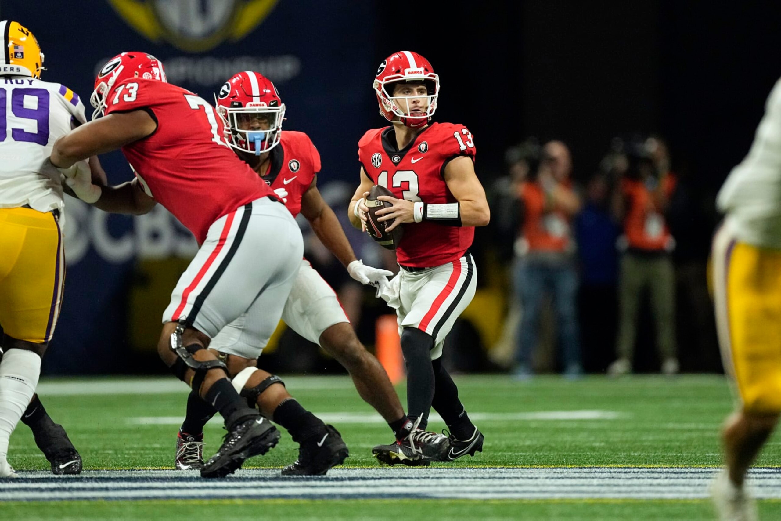 Georgia quarterback Stetson Bennett (13) looks for an open receiver in the first half of the Southeastern Conference Championship football game against the LSU Saturday, Dec. 3, 2022 in Atlanta. (AP Photo/John Bazemore)