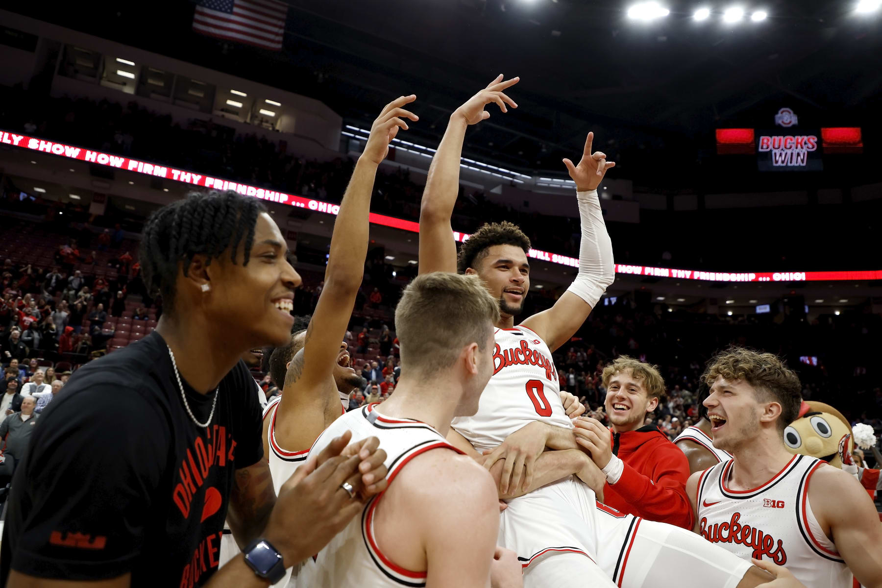 COLUMBUS, OH - DECEMBER 08:  Tanner Holden #0 of the Ohio State Buckeyes is congratulated by his teammates after scoring the game winning basket at the buzzer to defeat the Rutgers Scarlet Knights at the Jerome Schottenstein Center on December 8, 2022 in Columbus, Ohio. Ohio State defeated Rutgers 67-66. (Photo by Kirk Irwin/Getty Images)