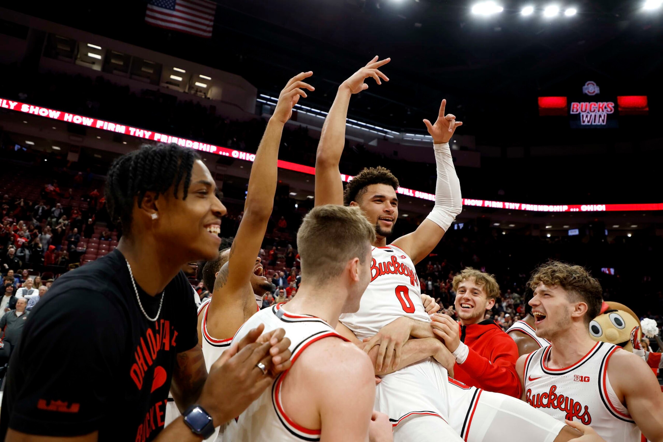 COLUMBUS, OH - DECEMBER 08:  Tanner Holden #0 of the Ohio State Buckeyes is congratulated by his teammates after scoring the game winning basket at the buzzer to defeat the Rutgers Scarlet Knights at the Jerome Schottenstein Center on December 8, 2022 in Columbus, Ohio. Ohio State defeated Rutgers 67-66. (Photo by Kirk Irwin/Getty Images)