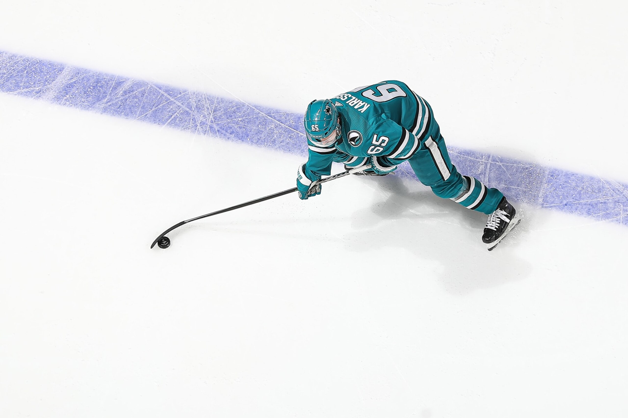 SAN JOSE, CA - NOVEMBER 21: An overhead view as Erik Karlsson #65 of the San Jose Sharks skates with the puck against the Ottawa Senators at SAP Center on November 21, 2022 in San Jose, California. (Photo by Kavin Mistry/NHLI via Getty Images) SAN JOSE, CA - NOVEMBER 21: An overhead view as Erik Karlsson #65 of the San Jose Sharks skates with the puck against the Ottawa Senators at SAP Center on November 21, 2022 in San Jose, California. (Photo by Kavin Mistry/NHLI via Getty Images)
