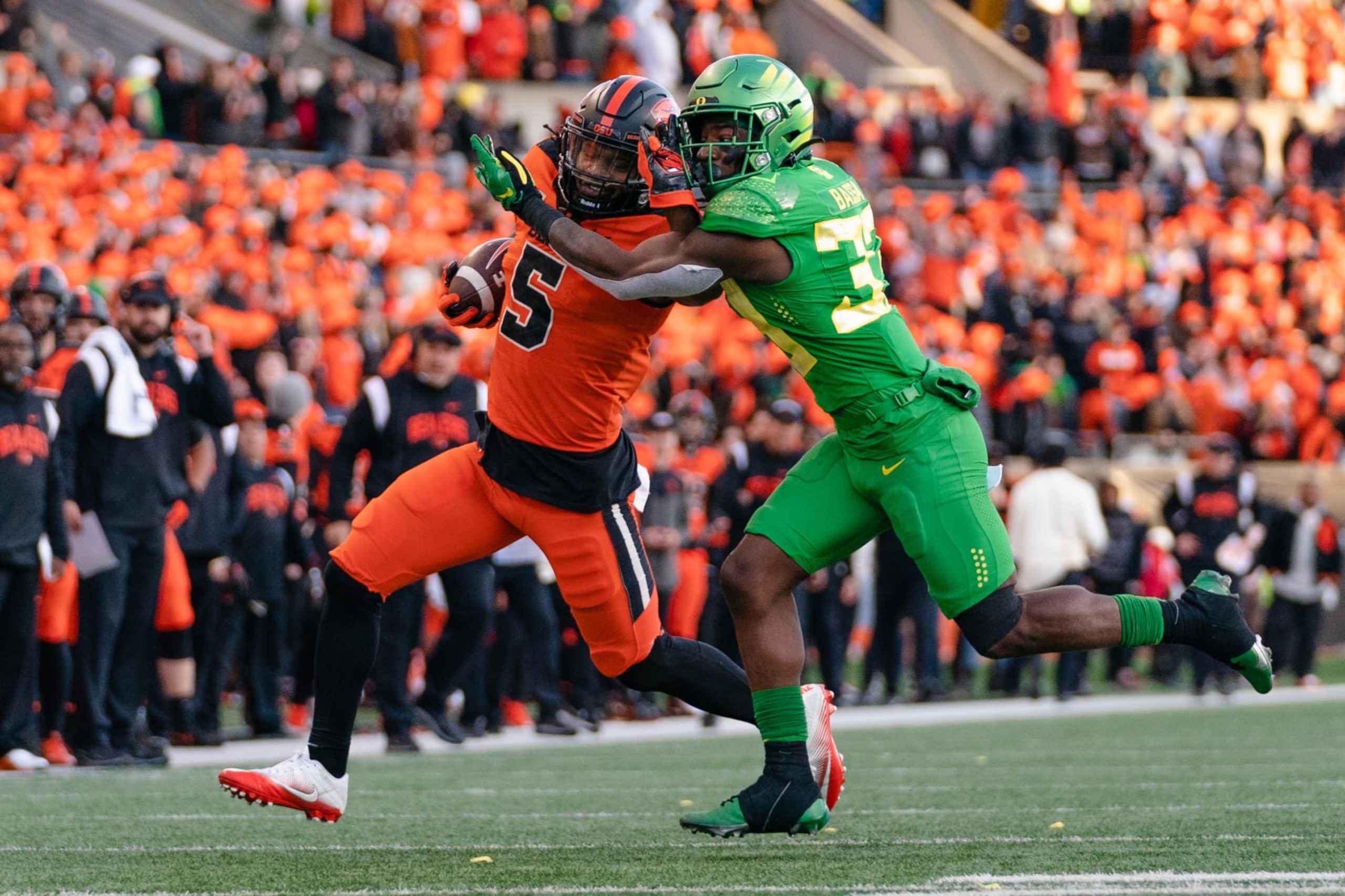CORVALLIS, OR - NOVEMBER 26: Running back Deshaun Fenwick #5 of the Oregon State Beavers runs the ball and fends off linebacker Jeffrey Bassa #33 of the Oregon Ducks during the second half of the game against the Oregon Ducks at Reser Stadium on November 26, 2022 in Corvallis, Oregon. (Photo by Ali Gradischer/Getty Images) CORVALLIS, OR - NOVEMBER 26: Running back Deshaun Fenwick #5 of the Oregon State Beavers runs the ball and fends off linebacker Jeffrey Bassa #33 of the Oregon Ducks during the second half of the game against the Oregon Ducks at Reser Stadium on November 26, 2022 in Corvallis, Oregon. (Photo by Ali Gradischer/Getty Images)