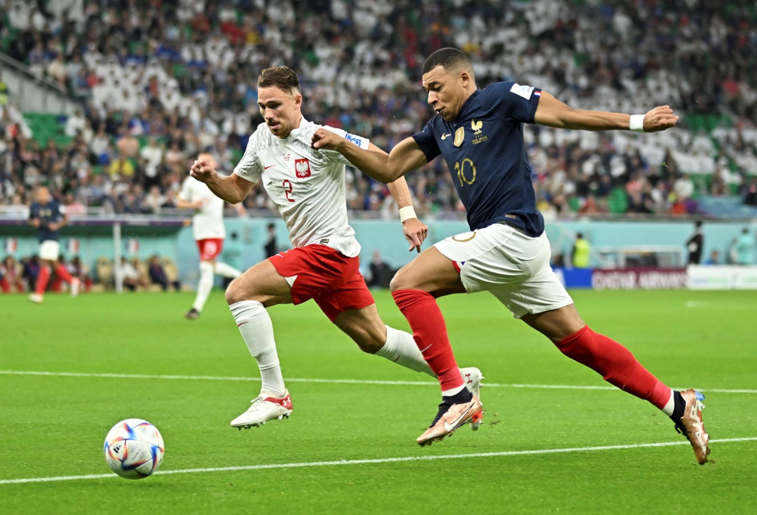 Matty Cash L of Poland vies with Kylian Mbappe of France during the Round of 16 match between France and Poland of the 2022 FIFA World Cup at Al Thumama Stadium in Doha, Qatar, Dec. 4, 2022. (Photo by Xiao Yijiu/Xinhua via Getty Images)