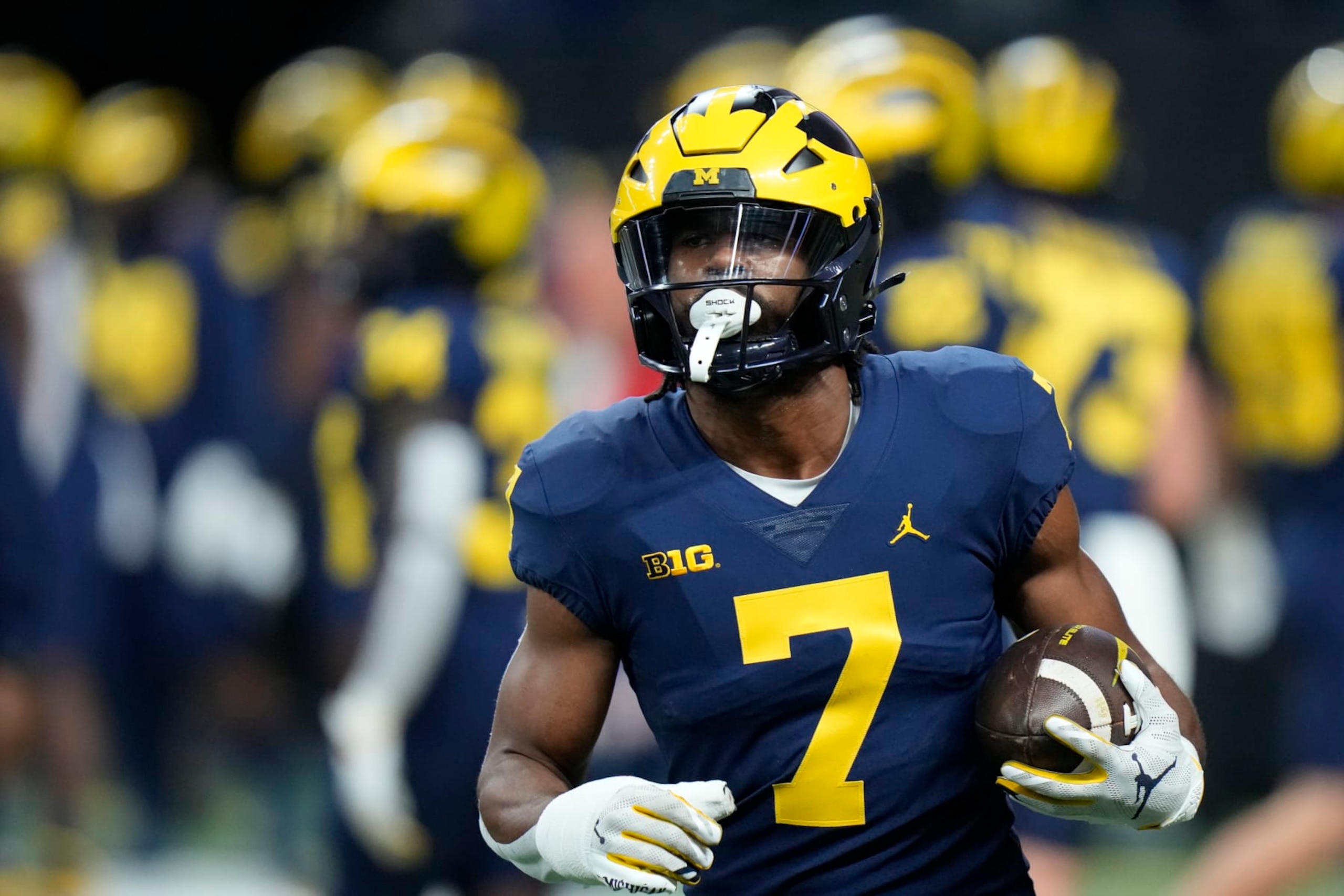 Michigan running back Donovan Edwards warms up before the start of the Big Ten championship NCAA college football game between Michigan and Purdue, Saturday, Dec. 3, 2022, in Indianapolis. (AP Photo/AJ Mast)
