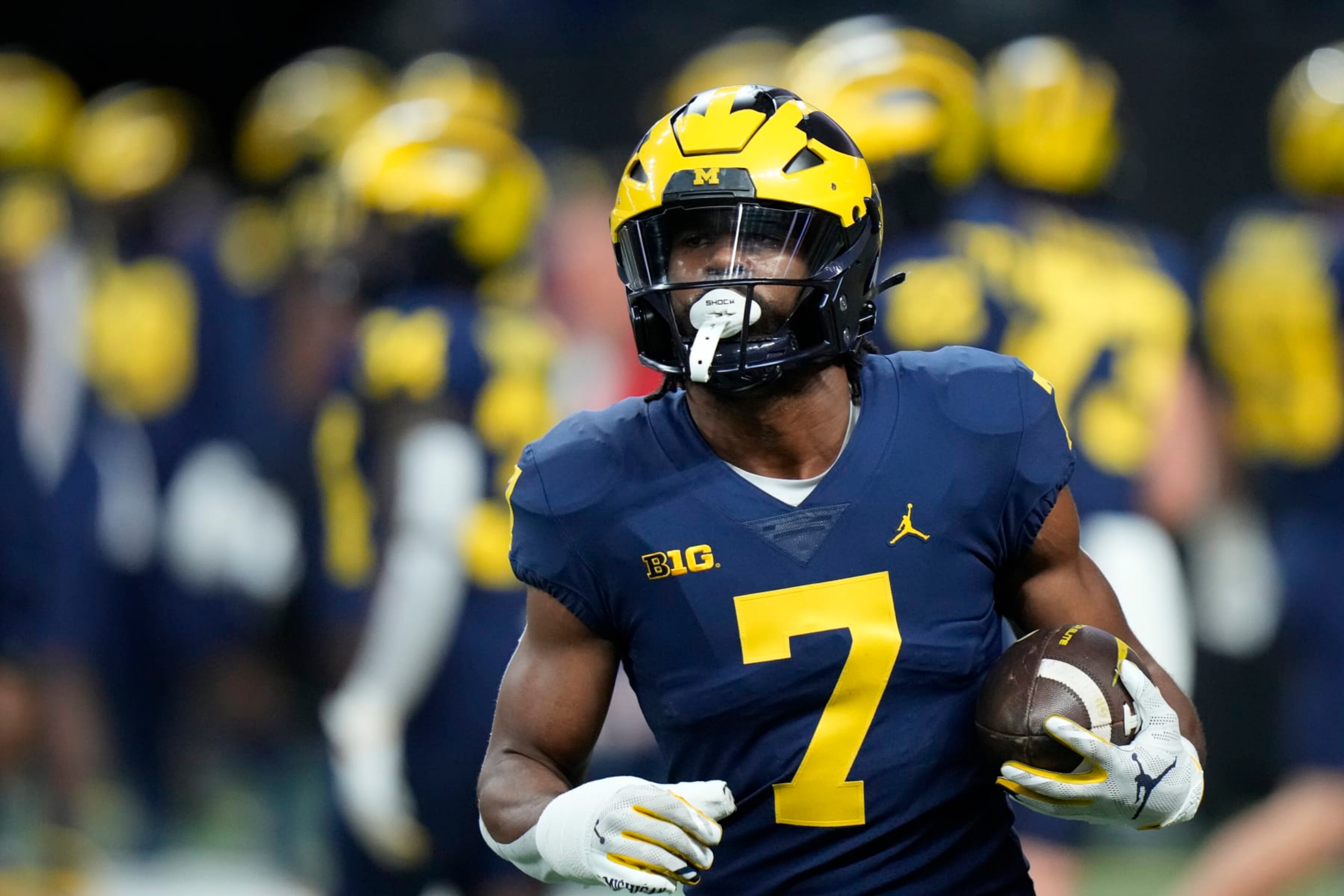 Michigan running back Donovan Edwards warms up before the start of the Big Ten championship NCAA college football game between Michigan and Purdue, Saturday, Dec. 3, 2022, in Indianapolis. (AP Photo/AJ Mast) Michigan running back Donovan Edwards warms up before the start of the Big Ten championship NCAA college football game between Michigan and Purdue, Saturday, Dec. 3, 2022, in Indianapolis. (AP Photo/AJ Mast)