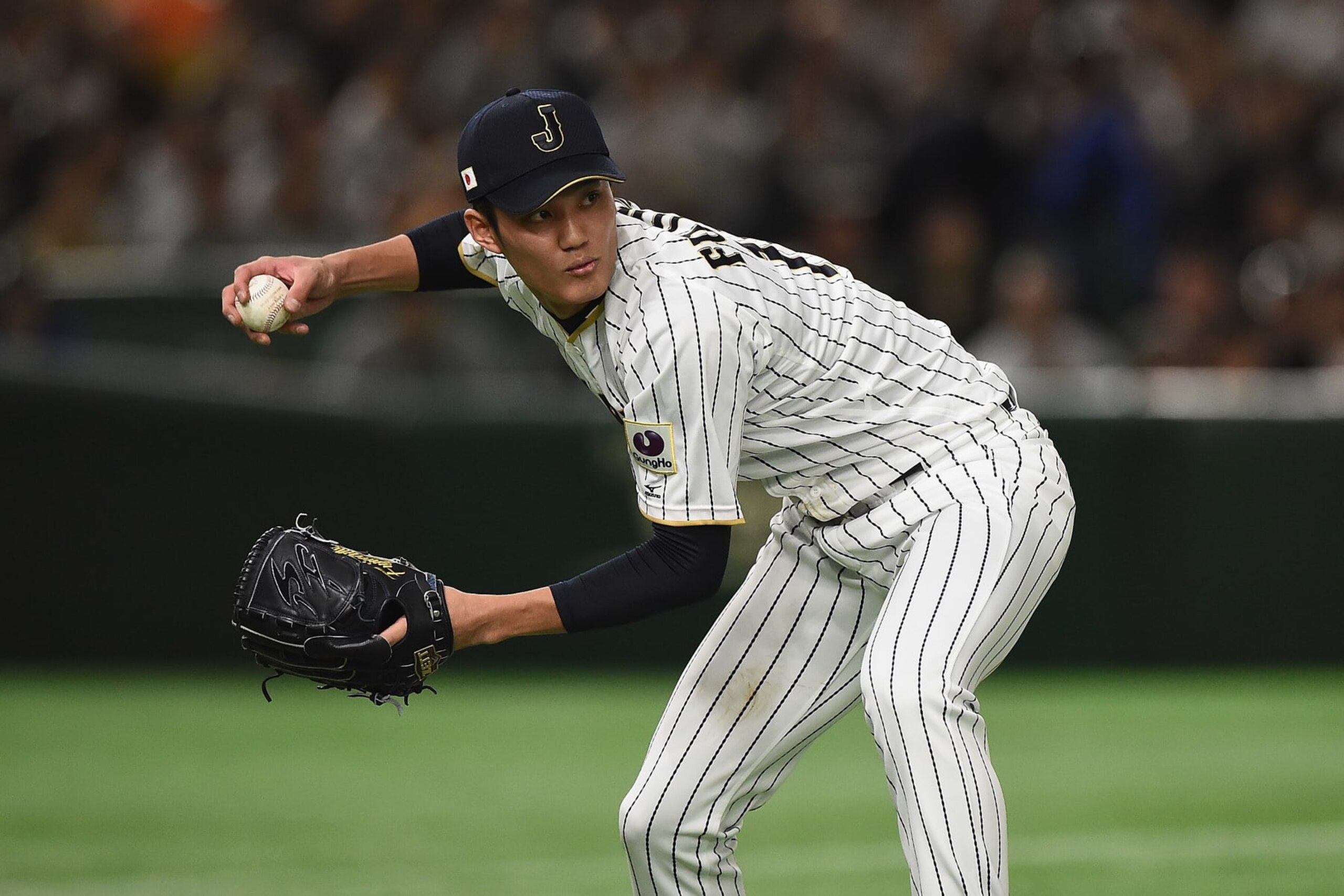 TOKYO, JAPAN - MARCH 10:  Pitcher Shintaro Fujinami #17 of Japan throws to first base in the top of the fourth inning during the World Baseball Classic Pool B Game Six between China and Japan at Tokyo Dome on March 10, 2017 in Tokyo, Japan.  (Photo by Matt Roberts/Getty Images)