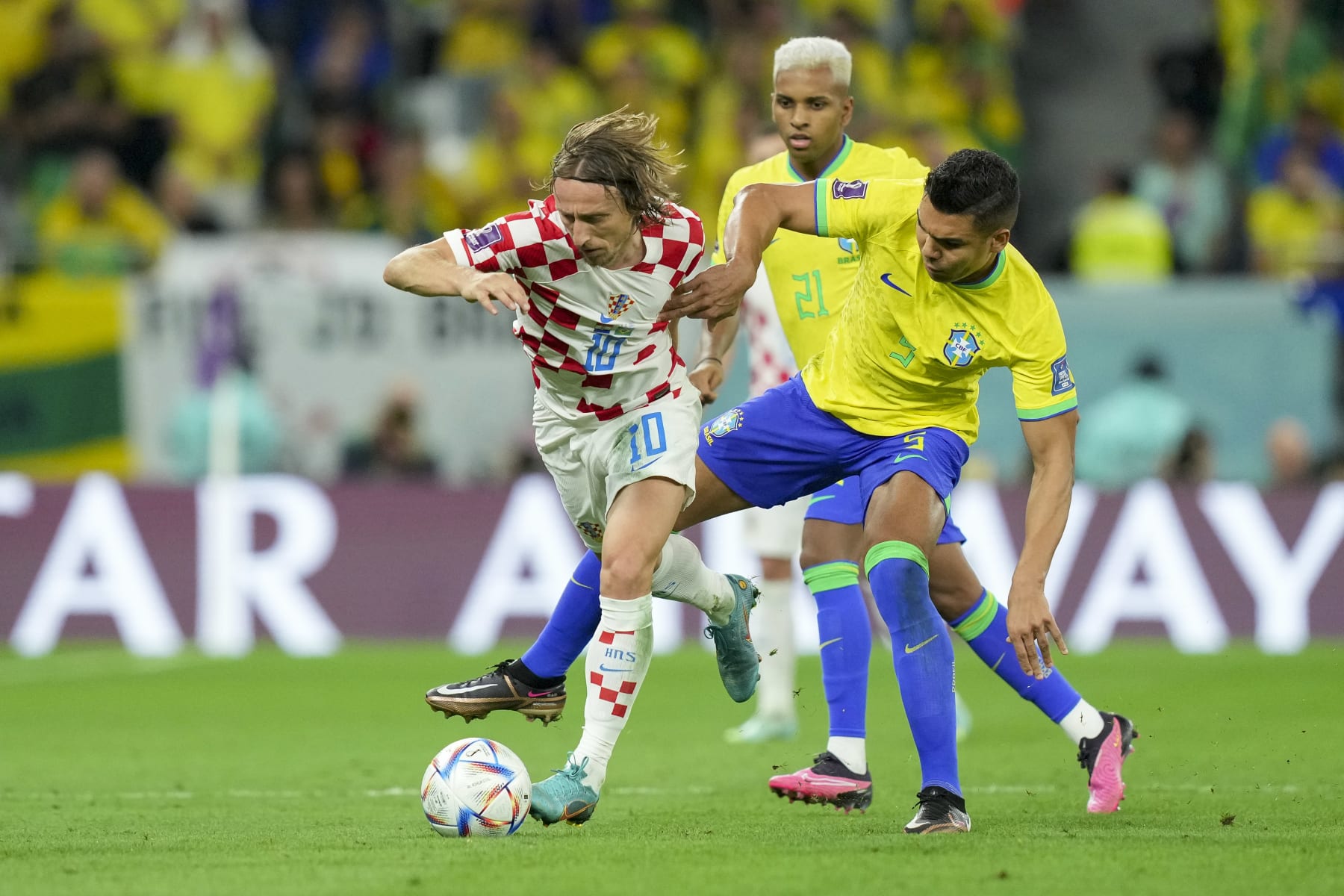 AL RAYYAN, QATAR - DECEMBER 09: Luka Modric of Croatia and Casemiro of Brazil battle for the ball during the FIFA World Cup Qatar 2022 quarter final match between Croatia and Brazil at Education City Stadium on December 9, 2022 in Al Rayyan, Qatar. (Photo by Mohammad Karamali/DeFodi Images via Getty Images)