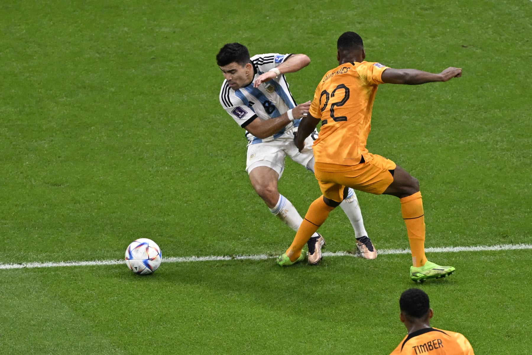 Argentina's defender #08 Marcos Acuna (L) fights for the ball with Netherlands' defender #22 Denzel Dumfries during the Qatar 2022 World Cup quarter-final football match between The Netherlands and Argentina at Lusail Stadium, north of Doha on December 9, 2022. (Photo by PATRICIA DE MELO MOREIRA / AFP) (Photo by PATRICIA DE MELO MOREIRA/AFP via Getty Images)