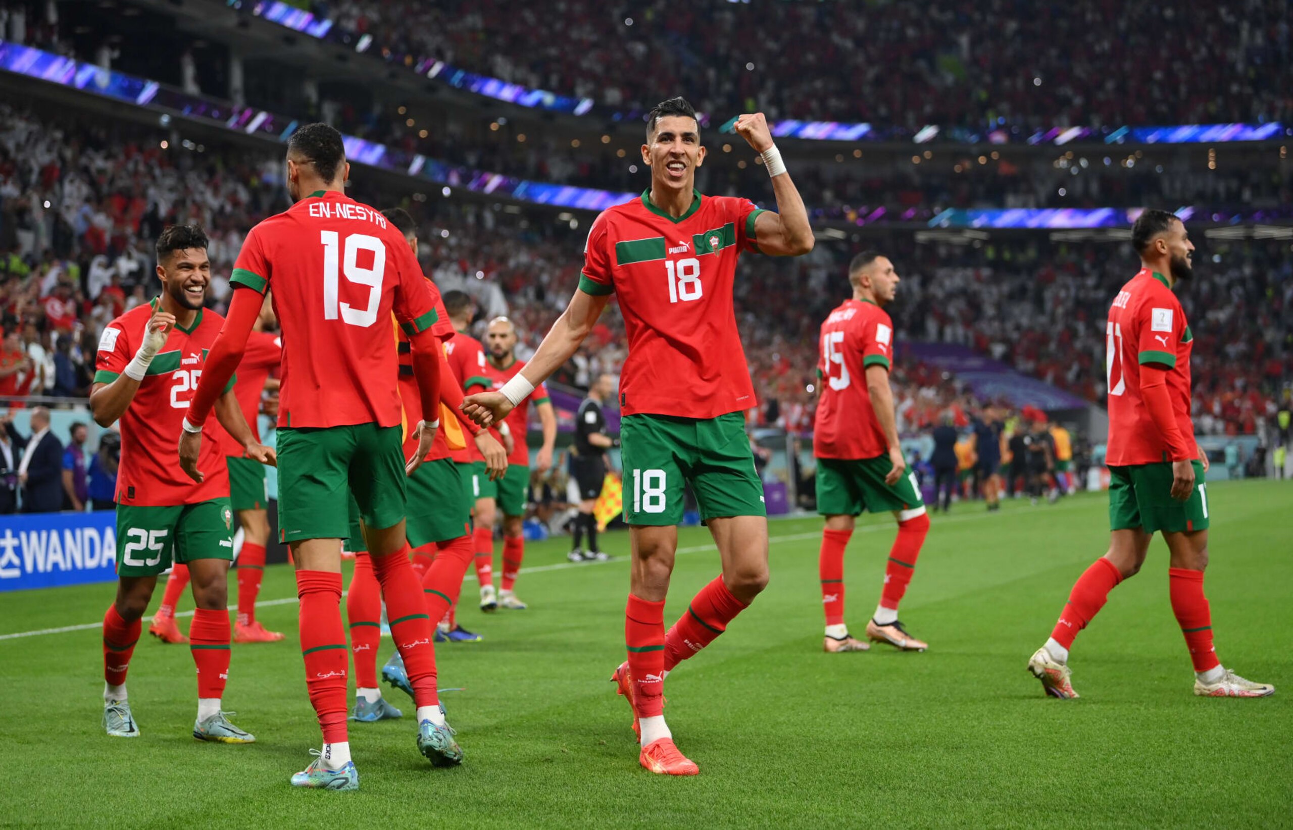 DOHA, QATAR - DECEMBER 10: Jawad El Yamiq (C) of Morocco  and Youssef En-Nesyri (L) of Morocco celebrate after scoring the team's first goal during the FIFA World Cup Qatar 2022 quarter final match between Morocco and Portugal at Al Thumama Stadium on December 10, 2022 in Doha, Qatar. (Photo by Justin Setterfield/Getty Images)