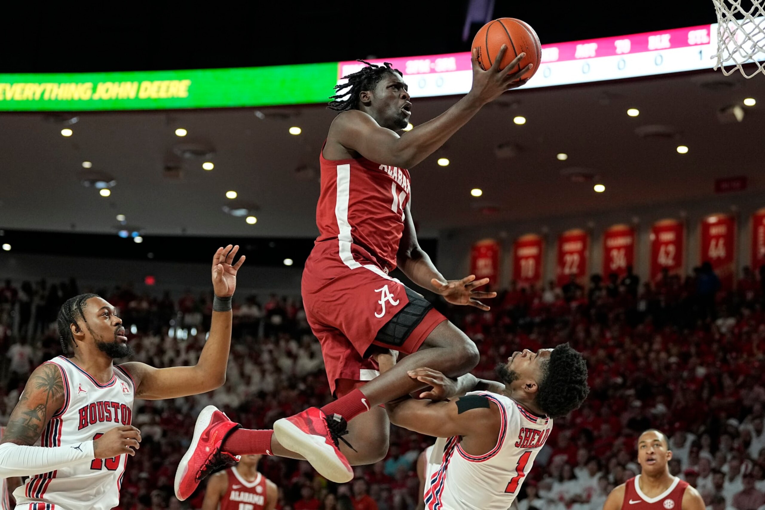 Alabama center Charles Bediako (14) is fouled by Houston guard Jamal Shead (1), right, during the first half of an NCAA college basketball game, Saturday, Dec. 10, 2022, in Houston. (AP Photo/Kevin M. Cox)