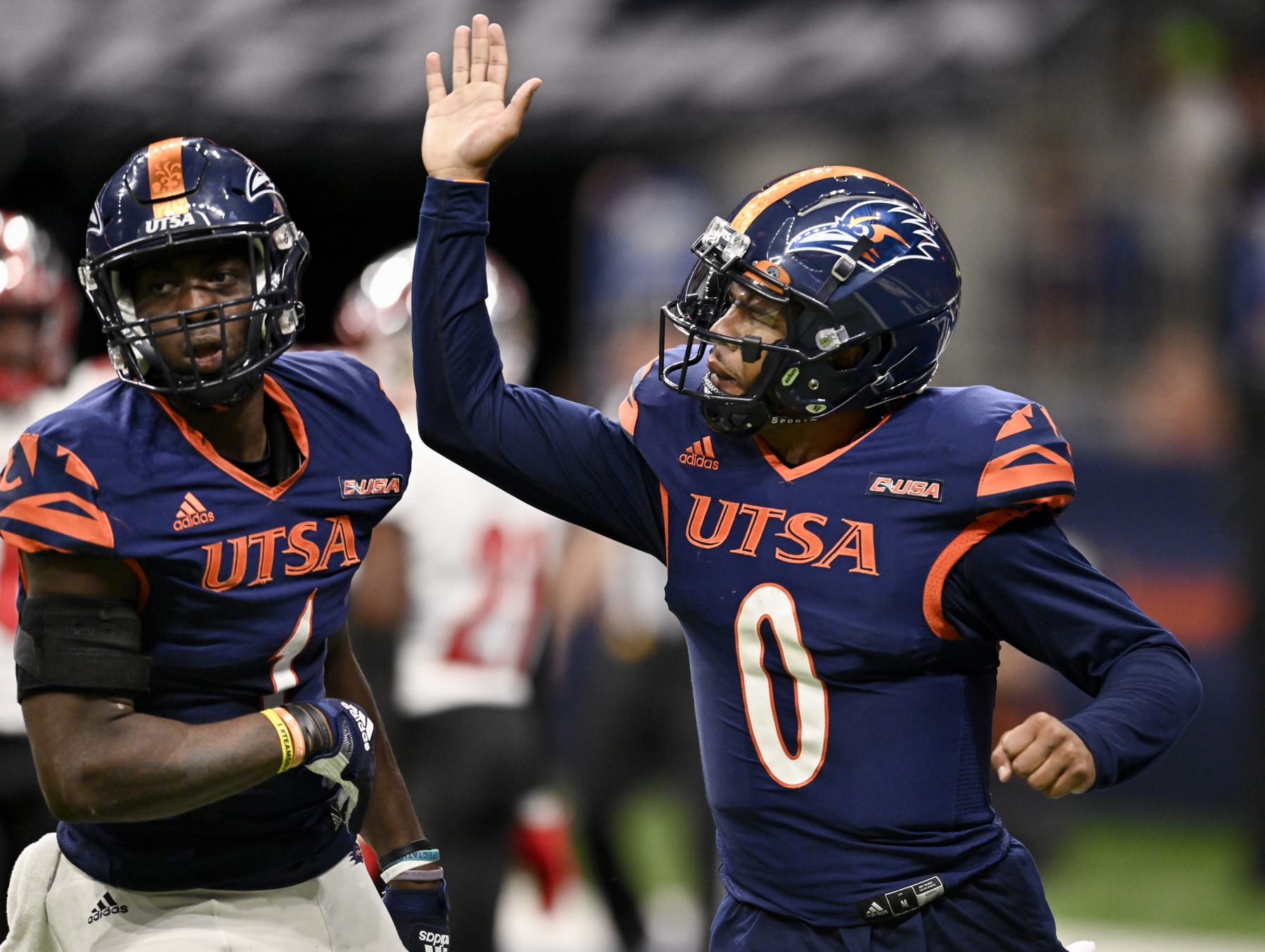 UTSA quarterback Frank Harris (0) congratulates teammate De'Corian Clark for his touchdown reception during the second half of an NCAA football game against Western Kentucky, Saturday, Oct. 8, 2022, in San Antonio. UTSA won 31-28. (AP Photo/Darren Abate)