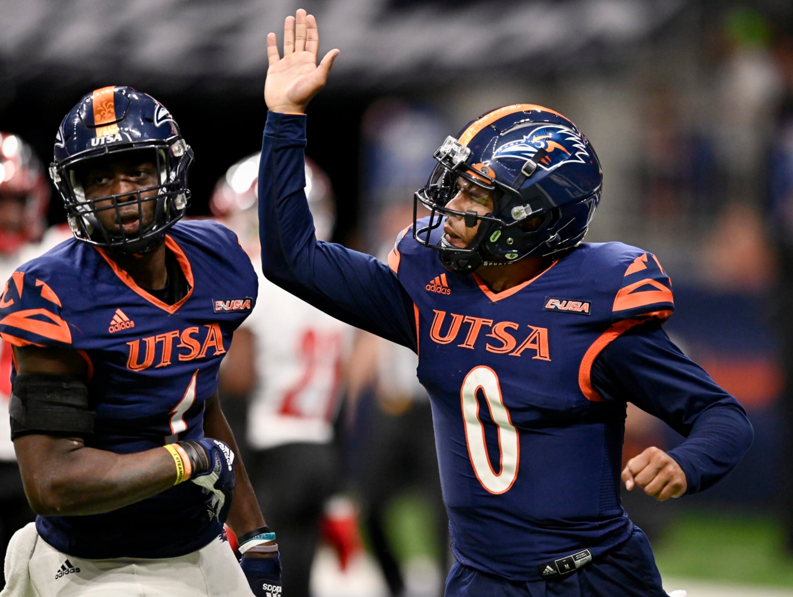 UTSA quarterback Frank Harris (0) congratulates teammate De'Corian Clark for his touchdown reception during the second half of an NCAA football game against Western Kentucky, Saturday, Oct. 8, 2022, in San Antonio. UTSA won 31-28. (AP Photo/Darren Abate)