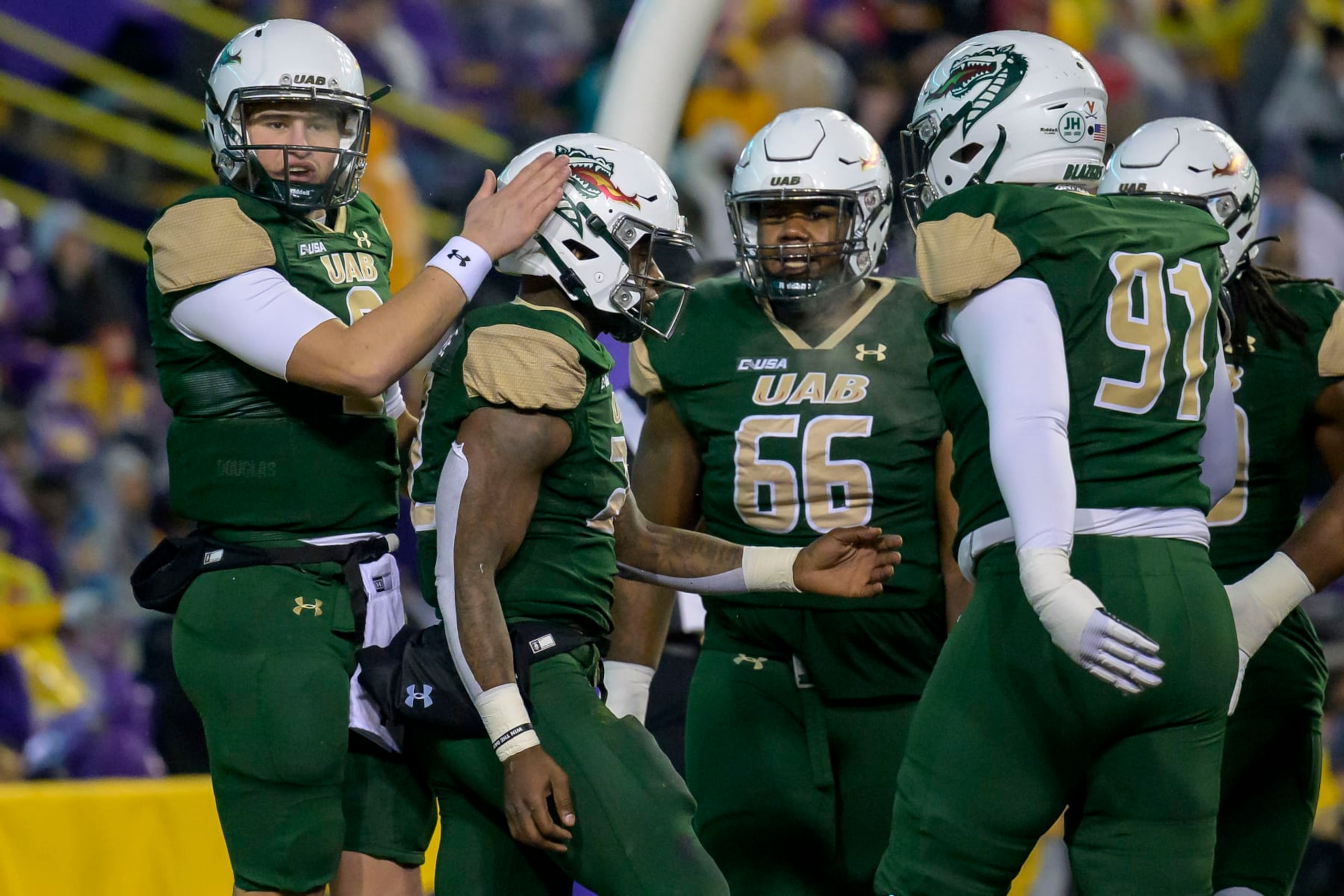 UAB quarterback Dylan Hopkins (9), left, celebrates the touchdown UAB running back DeWayne McBride (22), second left, during the first half of an NCAA college football game against LSU in Baton Rouge, La., Saturday, Nov. 19, 2022. (AP Photo/Matthew Hinton)