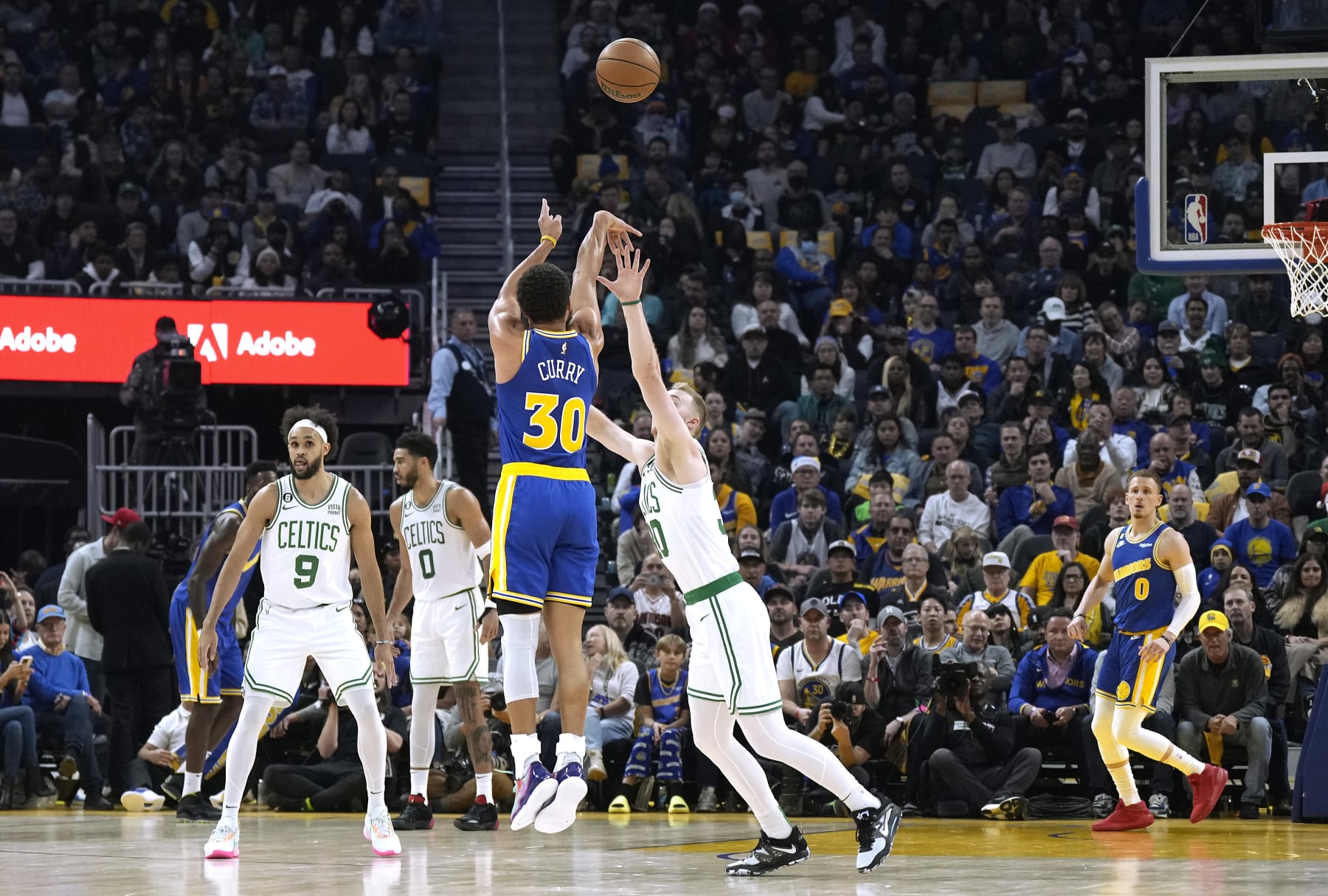 SAN FRANCISCO, CALIFORNIA - DECEMBER 10: Stephen Curry #30 of the Golden State Warriors shoots and make a three-point shot at the buzzer over Luke Kornet #40 of the Boston Celtics at the end of the first quarter of an NBA basketball game at Chase Center on December 10, 2022 in San Francisco, California. NOTE TO USER: User expressly acknowledges and agrees that, by downloading and or using this photograph, User is consenting to the terms and conditions of the Getty Images License Agreement. (Photo by Thearon W. Henderson/Getty Images)