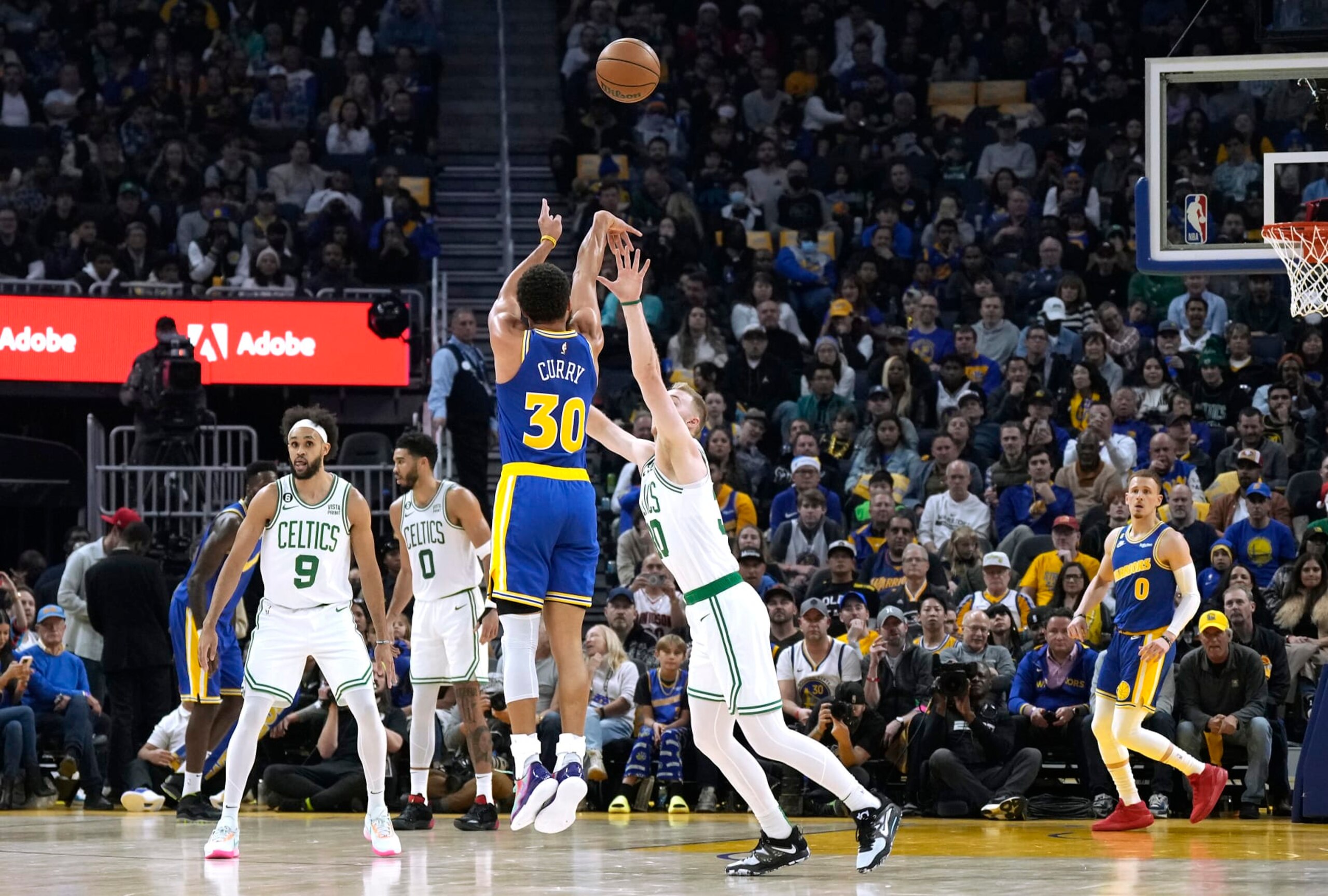 SAN FRANCISCO, CALIFORNIA - DECEMBER 10: Stephen Curry #30 of the Golden State Warriors shoots and make a three-point shot at the buzzer over Luke Kornet #40 of the Boston Celtics at the end of the first quarter of an NBA basketball game at Chase Center on December 10, 2022 in San Francisco, California. NOTE TO USER: User expressly acknowledges and agrees that, by downloading and or using this photograph, User is consenting to the terms and conditions of the Getty Images License Agreement. (Photo by Thearon W. Henderson/Getty Images) SAN FRANCISCO, CALIFORNIA - DECEMBER 10: Stephen Curry #30 of the Golden State Warriors shoots and make a three-point shot at the buzzer over Luke Kornet #40 of the Boston Celtics at the end of the first quarter of an NBA basketball game at Chase Center on December 10, 2022 in San Francisco, California. NOTE TO USER: User expressly acknowledges and agrees that, by downloading and or using this photograph, User is consenting to the terms and conditions of the Getty Images License Agreement. (Photo by Thearon W. Henderson/Getty Images)