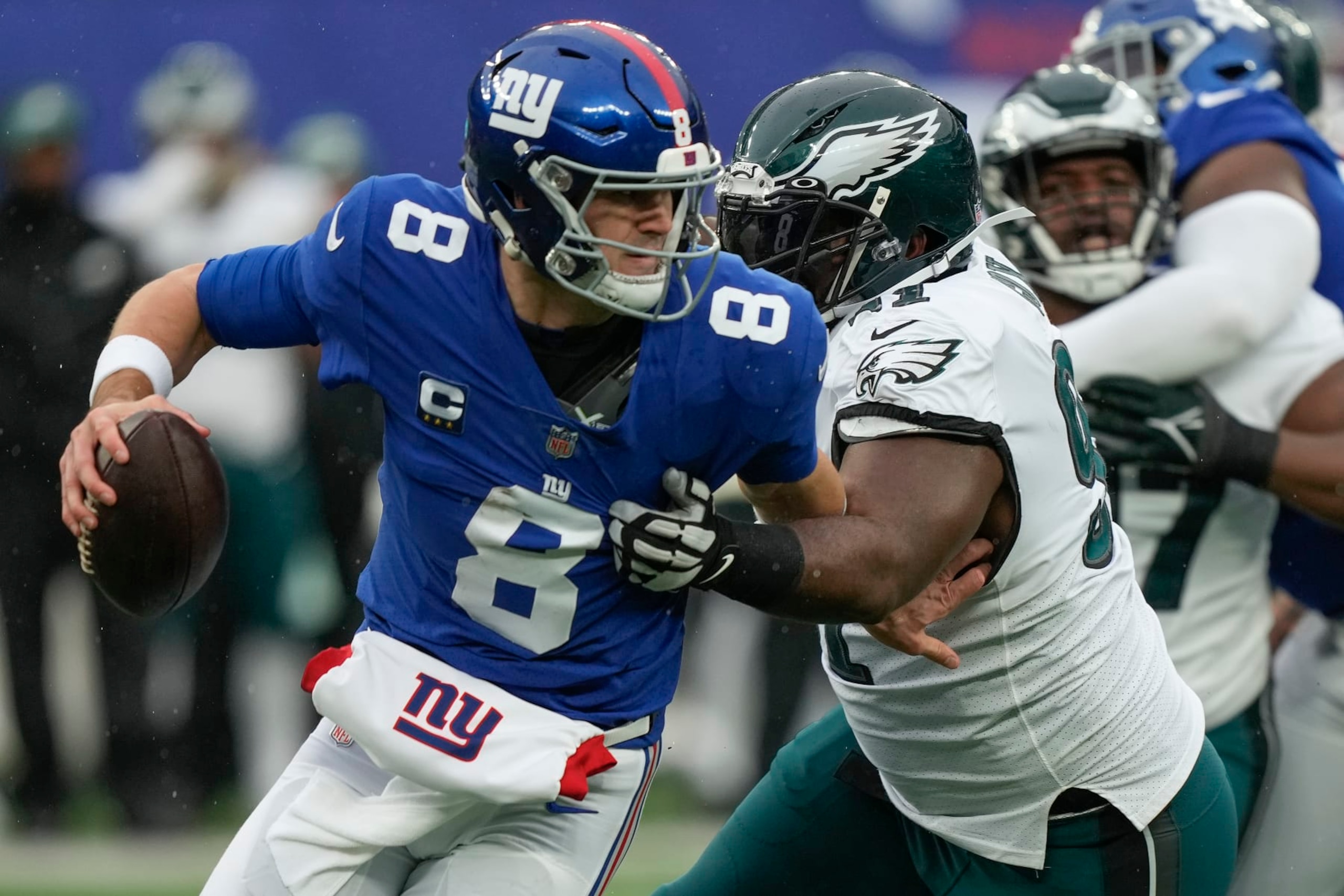New York Giants quarterback Daniel Jones (8) is pressured by Philadelphia Eagles defensive tackle Fletcher Cox (91) during the second quarter of an NFL football game, Sunday, Dec. 11, 2022, in East Rutherford, N.J. (AP Photo/Bryan Woolston)