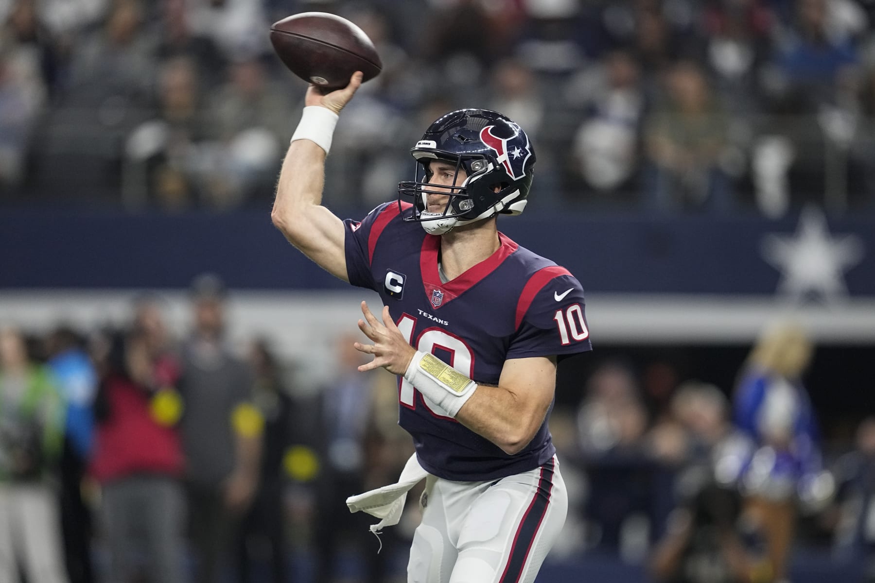 Houston Texans quarterback Davis Mills (10) throws a pass against the Dallas Cowboys in the first half of an NFL football game, Sunday, Dec. 11, 2022, in Arlington, Texas. (AP Photo/Tony Gutierrez)