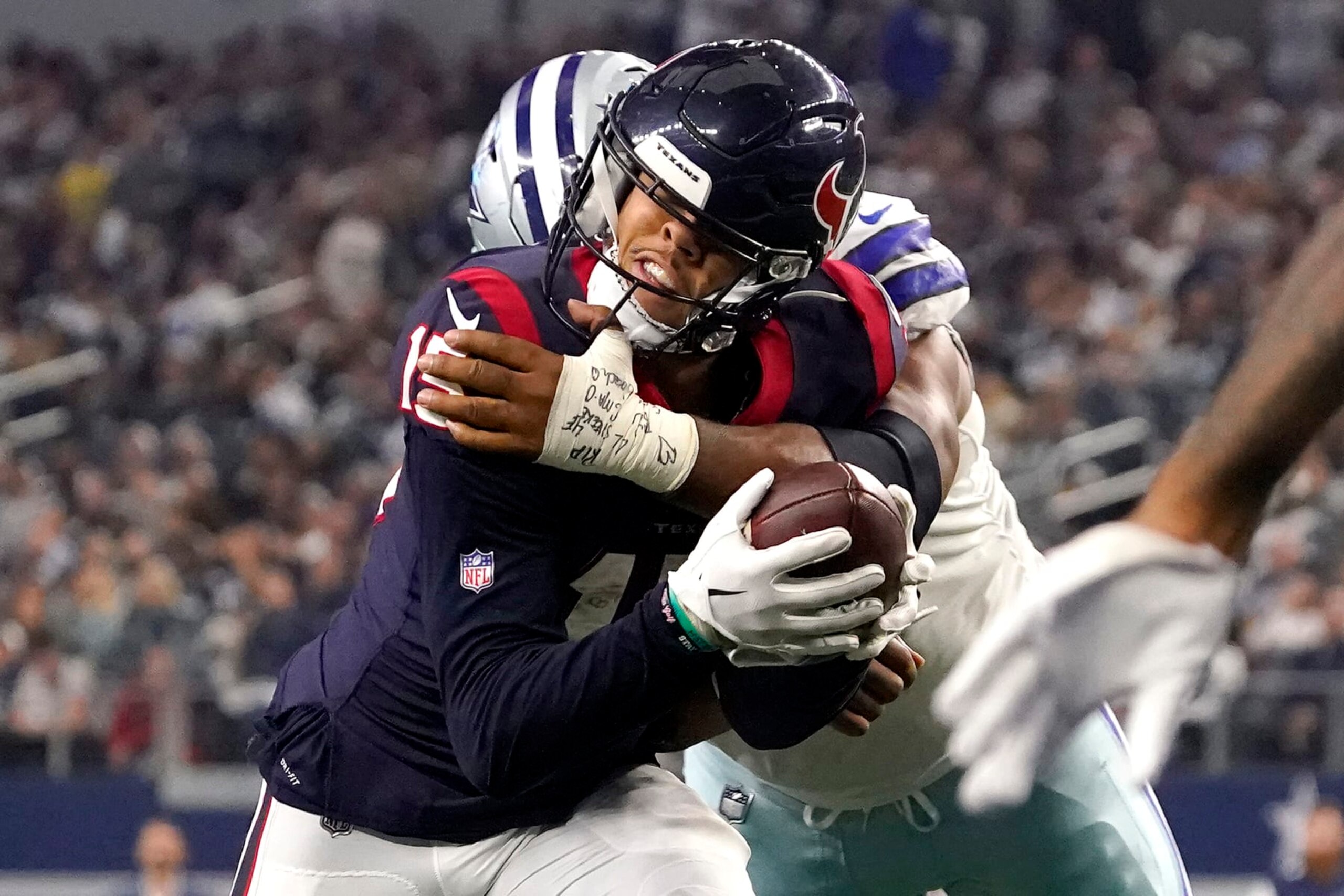 ARLINGTON, TEXAS - DECEMBER 11: Chris Moore #15 of the Houston Texans gets hit by Carlos Watkins #91 of the Dallas Cowboys in the fourth quarter of a game AT&T Stadium on December 11, 2022 in Arlington, Texas. (Photo by Sam Hodde/Getty Images) ARLINGTON, TEXAS - DECEMBER 11: Chris Moore #15 of the Houston Texans gets hit by Carlos Watkins #91 of the Dallas Cowboys in the fourth quarter of a game AT&T Stadium on December 11, 2022 in Arlington, Texas. (Photo by Sam Hodde/Getty Images)