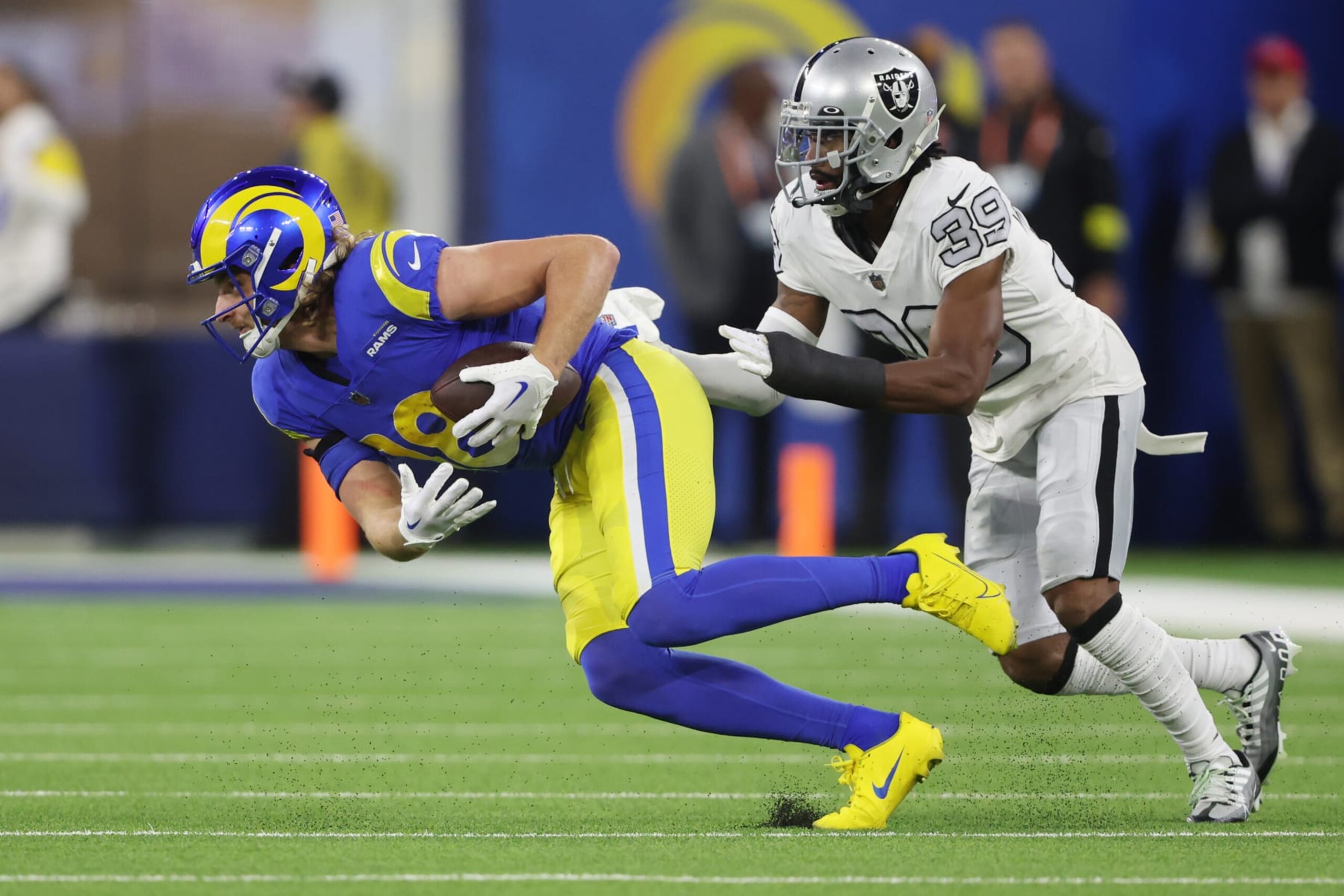 INGLEWOOD, CALIFORNIA - DECEMBER 08: Ben Skowronek #18 of the Los Angeles Rams evades the tackle attempt by Nate Hobbs #39 of the Las Vegas Raiders following a reception during the fourth quarter at SoFi Stadium on December 08, 2022 in Inglewood, California. (Photo by Sean M. Haffey/Getty Images)