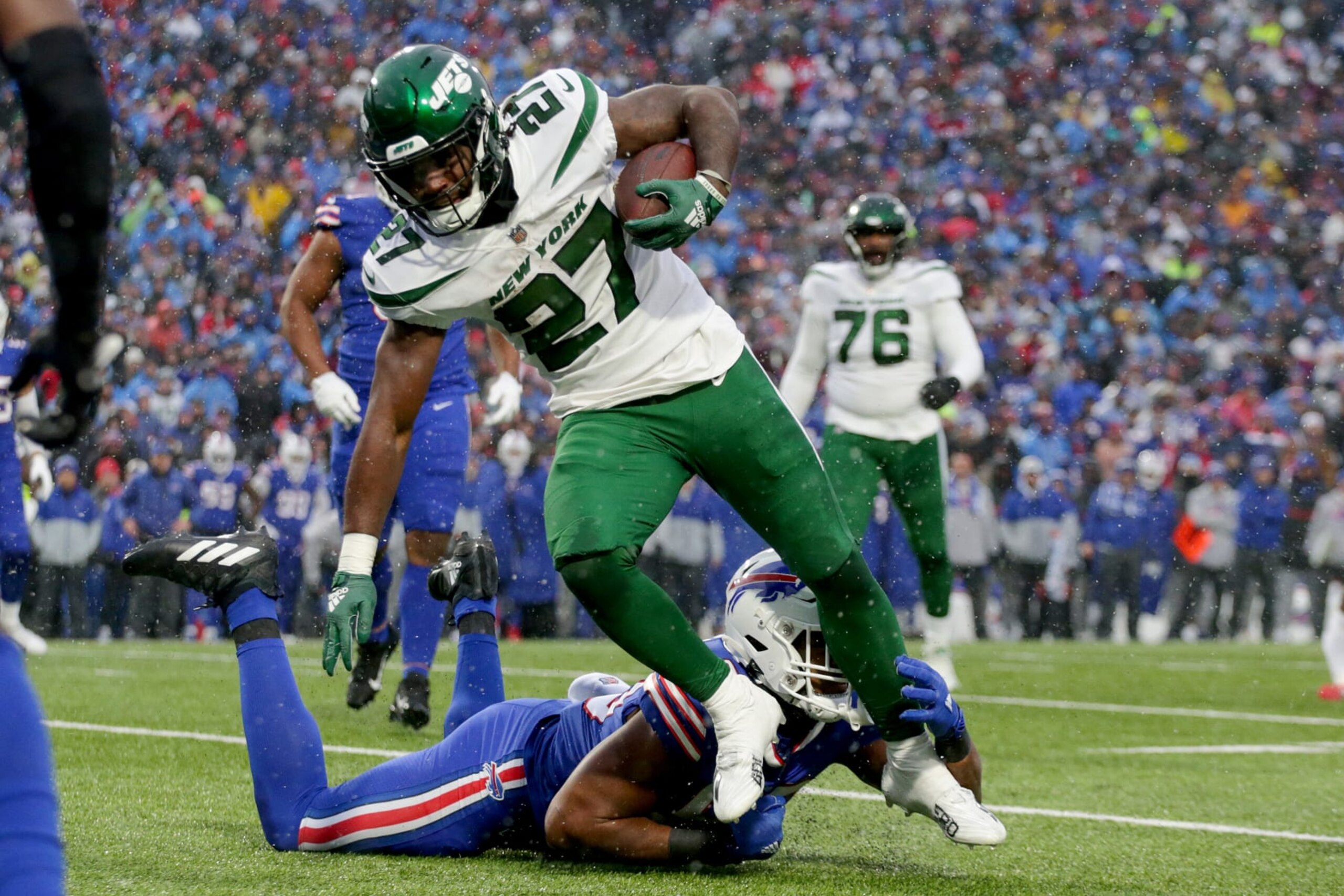 ORCHARD PARK, NEW YORK - DECEMBER 11: Zonovan Knight #27 of the New York Jets rushes for a touchdown in the third quarter of a game against the Buffalo Bills at Highmark Stadium on December 11, 2022 in Orchard Park, New York. (Photo by Joshua Bessex/Getty Images)