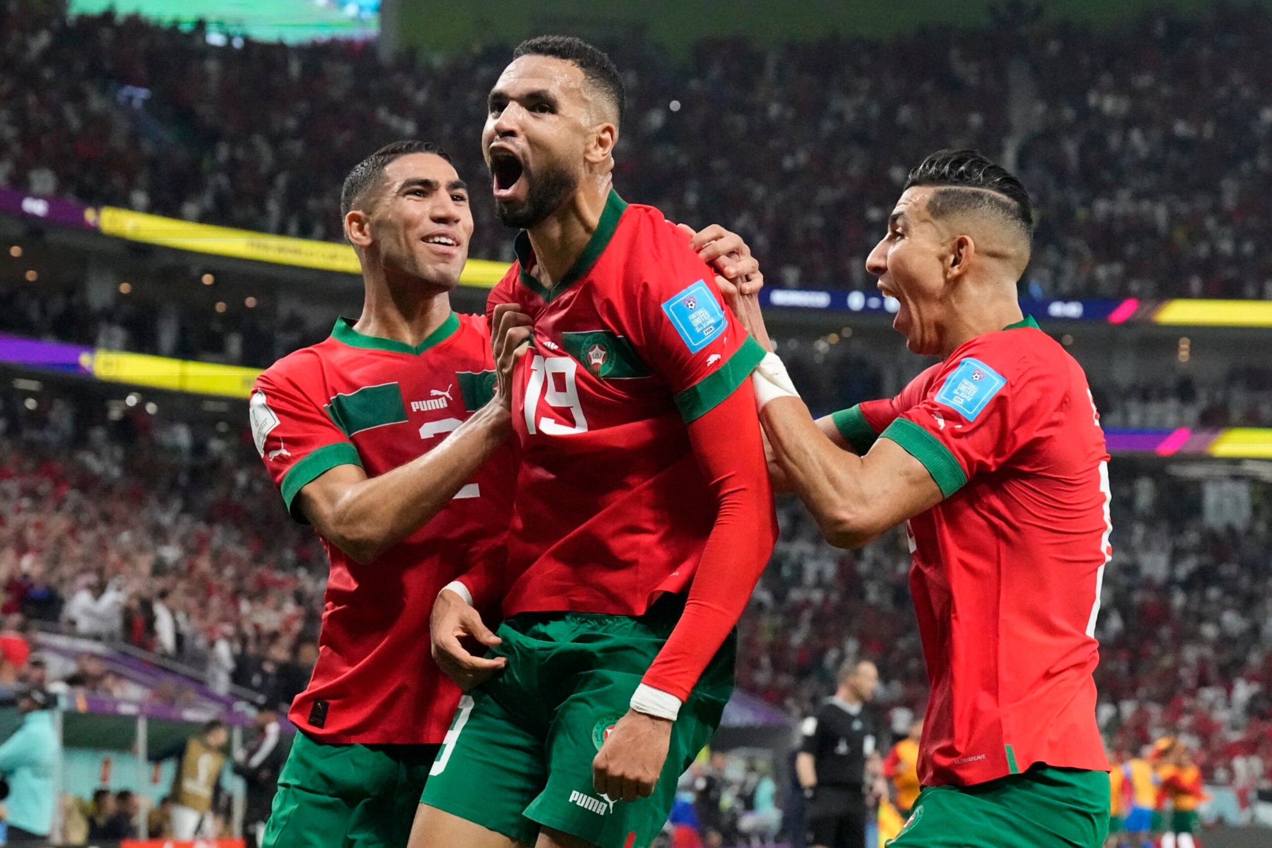 Morocco's Youssef En-Nesyri, center, celebrates after scoring his side's first goal during the World Cup quarterfinal soccer match between Morocco and Portugal, at Al Thumama Stadium in Doha, Qatar, Saturday, Dec. 10, 2022. (AP Photo/Martin Meissner)