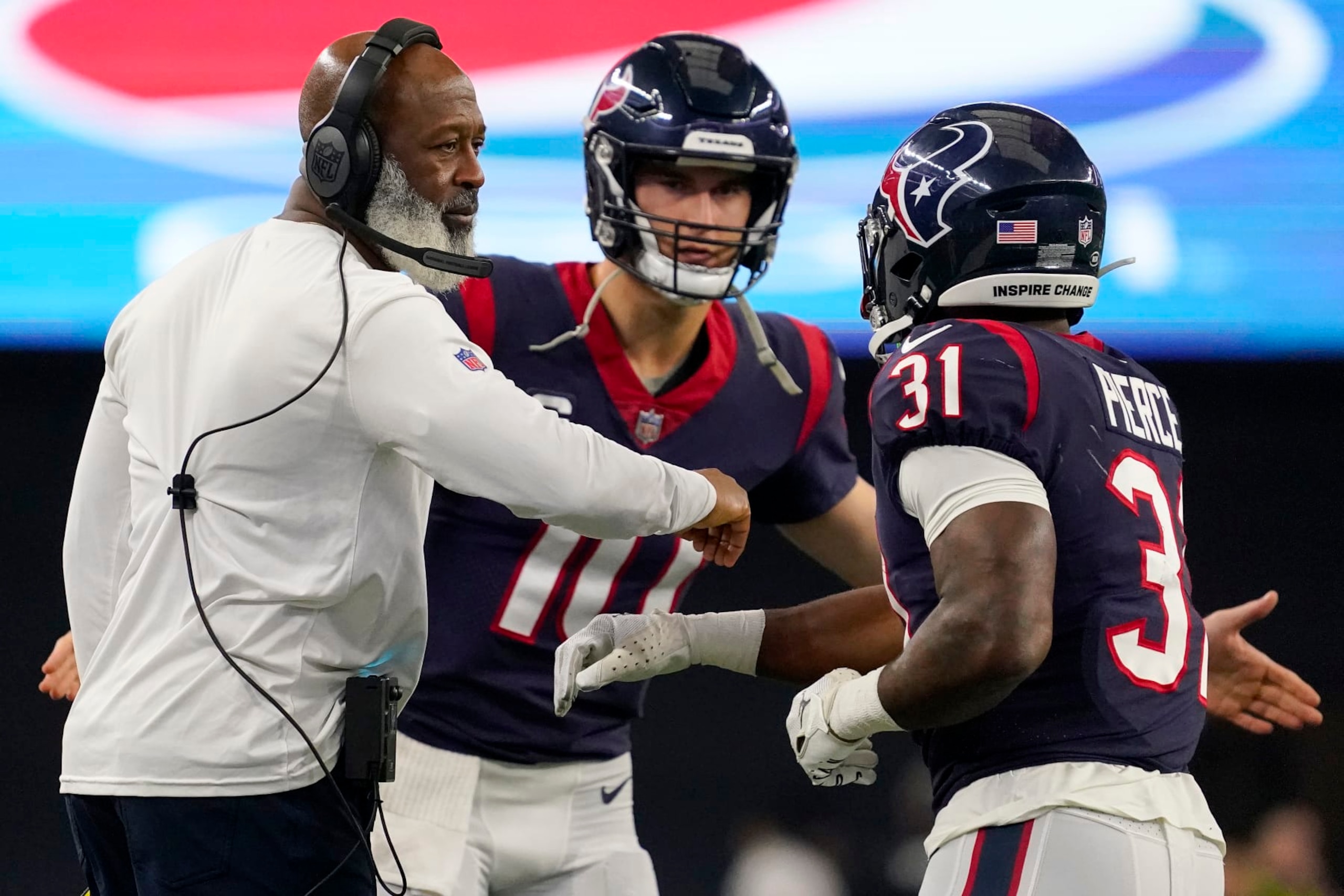 ARLINGTON, TEXAS - DECEMBER 11: Dameon Pierce #31 of the Houston Texans celebrates with head coach Lovie Smith of the Houston Texans after scoring a touchdown in the first half at AT&T Stadium on December 11, 2022 in Arlington, Texas. (Photo by Sam Hodde/Getty Images)