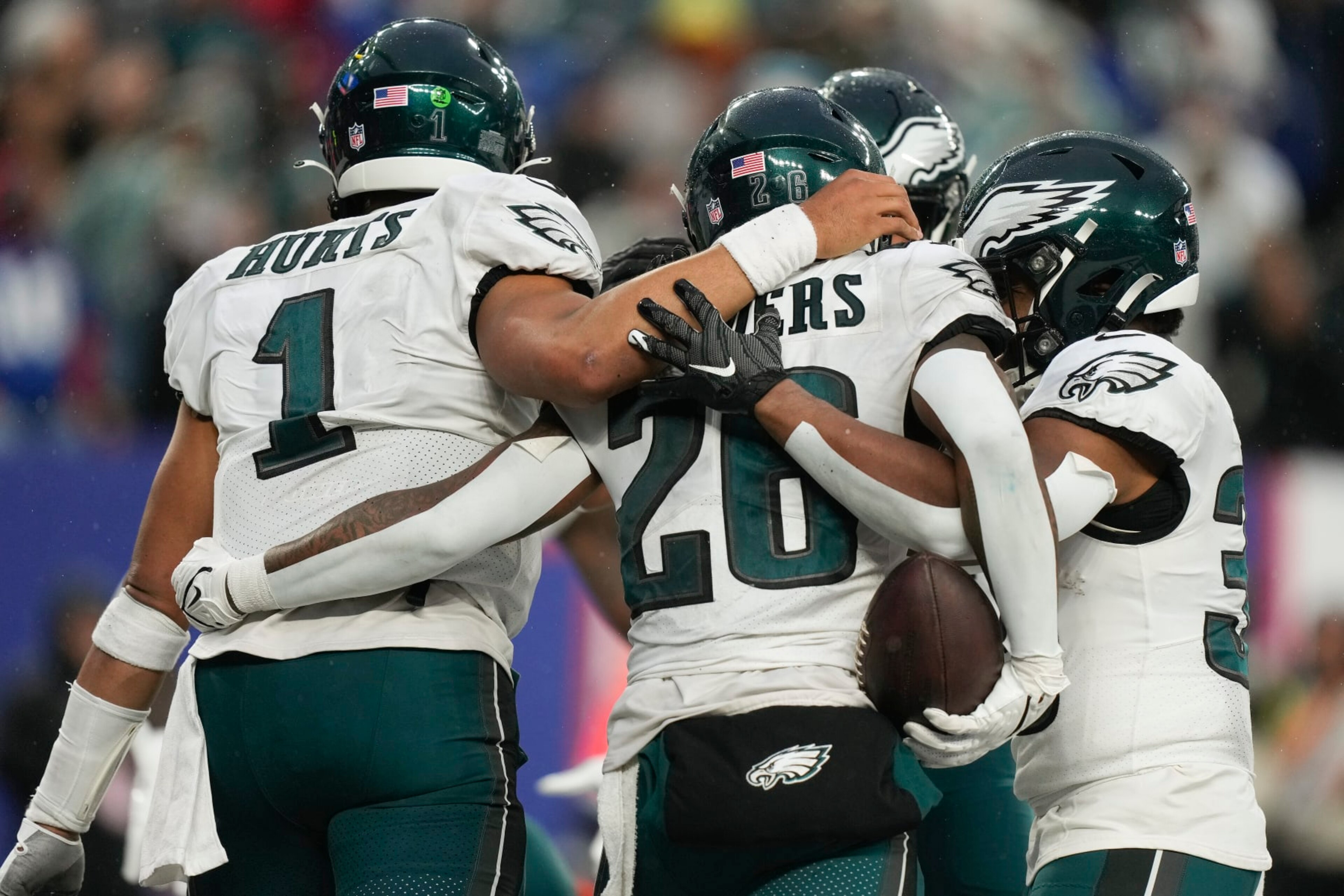 Philadelphia Eagles running back Miles Sanders (26) celebrates with quarterback Jalen Hurts (1) and teammates after scoring a touchdown against the New York Giants during the fourth quarter of an NFL football game, Sunday, Dec. 11, 2022, in East Rutherford, N.J. (AP Photo/Bryan Woolston) Philadelphia Eagles running back Miles Sanders (26) celebrates with quarterback Jalen Hurts (1) and teammates after scoring a touchdown against the New York Giants during the fourth quarter of an NFL football game, Sunday, Dec. 11, 2022, in East Rutherford, N.J. (AP Photo/Bryan Woolston)