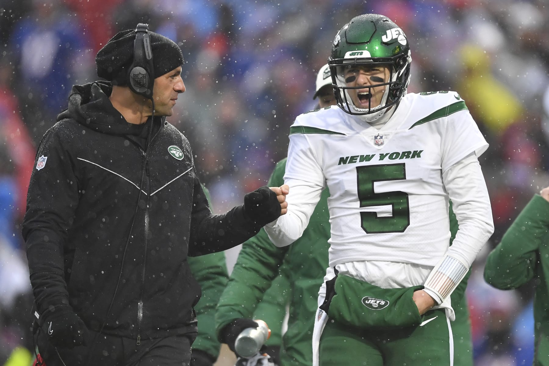 New York Jets head coach Robert Saleh speaks with New York Jets quarterback Mike White (5) during the first half of an NFL football game against the Buffalo Bills, Sunday, Dec. 11, 2022, in Orchard Park, N.Y. (AP Photo/Adrian Kraus)
