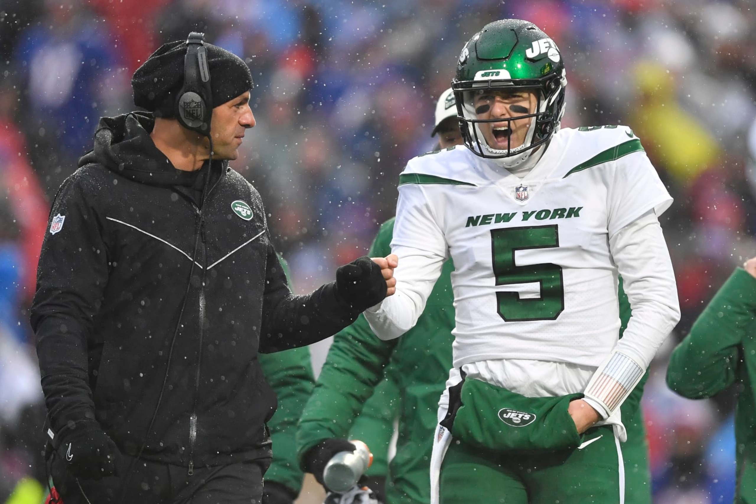 New York Jets head coach Robert Saleh speaks with New York Jets quarterback Mike White (5) during the first half of an NFL football game against the Buffalo Bills, Sunday, Dec. 11, 2022, in Orchard Park, N.Y. (AP Photo/Adrian Kraus)