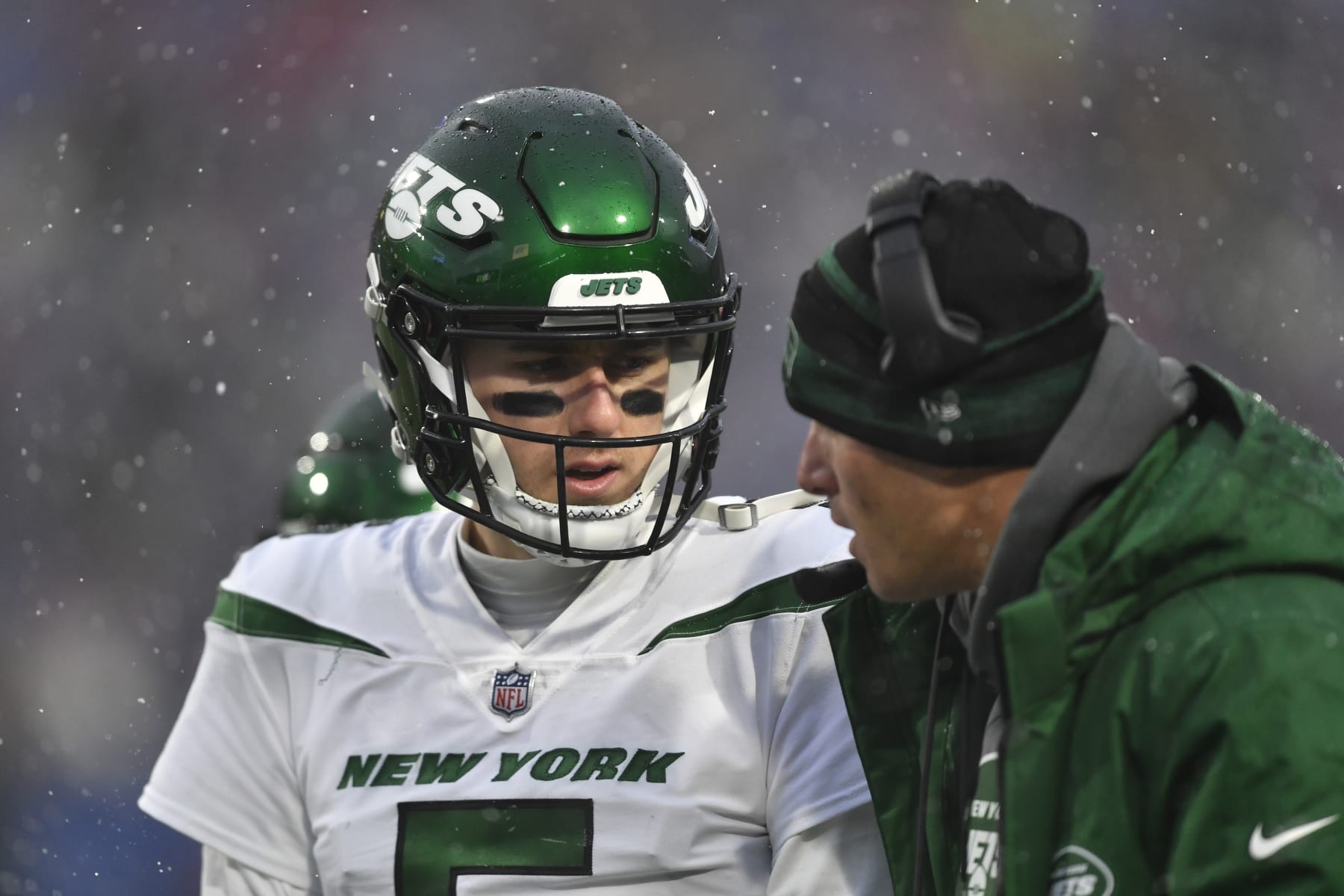 New York Jets quarterback Mike White, left, during the second half of an NFL football game against the Buffalo Bills, Sunday, Dec. 11, 2022, in Orchard Park, N.Y. (AP Photo/Adrian Kraus)