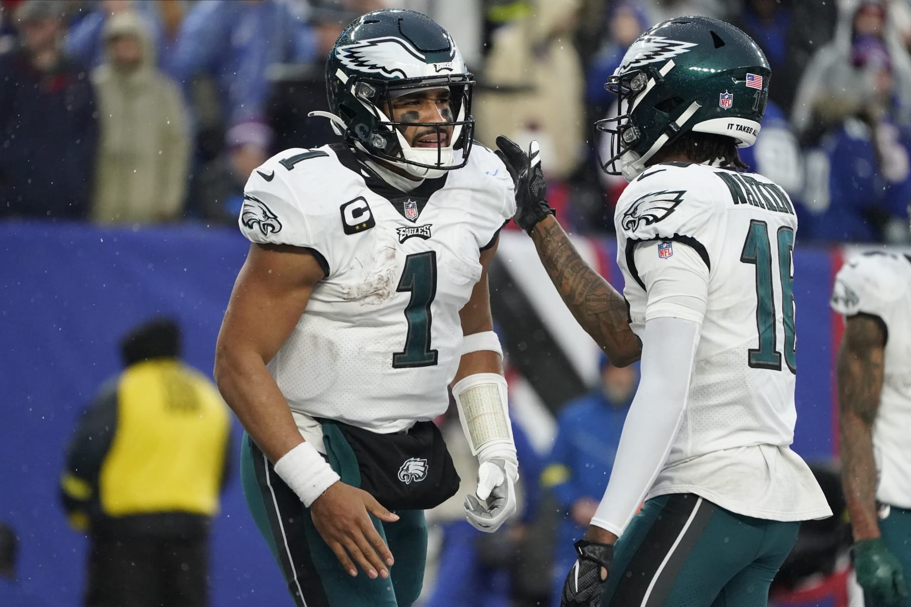 Philadelphia Eagles quarterback Jalen Hurts (1) is congratulated by wide receiver Quez Watkins (16) after scoring a touchdown against the New York Giants during the third quarter of an NFL football game, Sunday, Dec. 11, 2022, in East Rutherford, N.J. (AP Photo/John Minchillo)