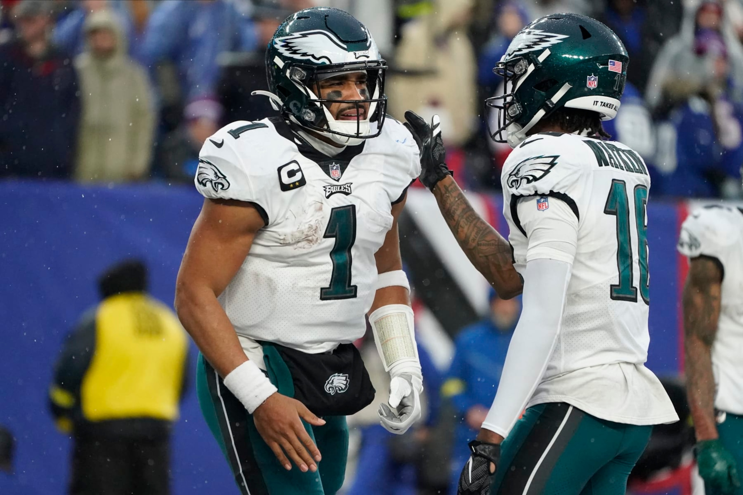 Philadelphia Eagles quarterback Jalen Hurts (1) is congratulated by wide receiver Quez Watkins (16) after scoring a touchdown against the New York Giants during the third quarter of an NFL football game, Sunday, Dec. 11, 2022, in East Rutherford, N.J. (AP Photo/John Minchillo)