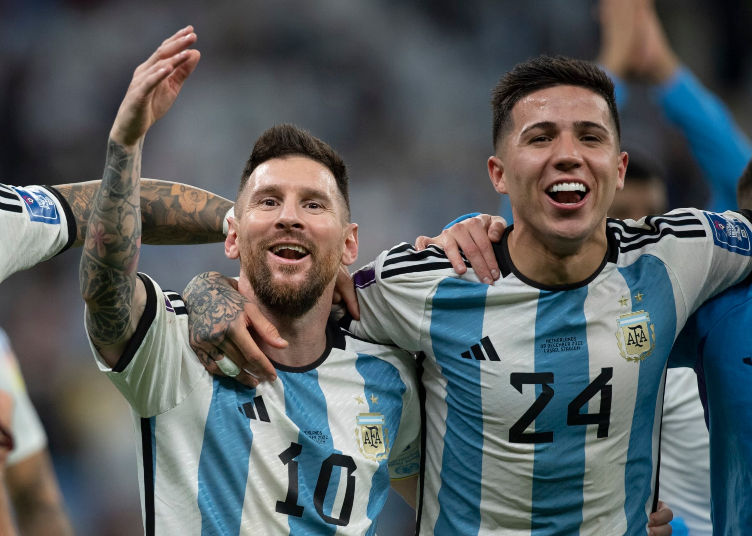 LUSAIL CITY, QATAR - DECEMBER 09: Lionel Messi and Enzo Fernandez of Argentina celebrate to fans following the FIFA World Cup Qatar 2022 quarter final match between Netherlands and Argentina at Lusail Stadium on December 9, 2022 in Lusail City, Qatar. (Photo by Visionhaus/Getty Images)