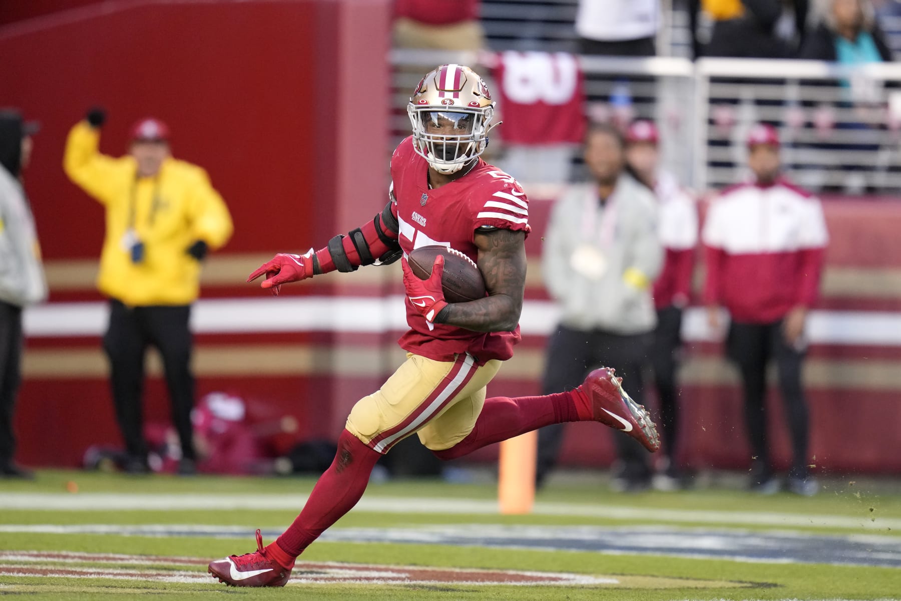 San Francisco 49ers linebacker Dre Greenlaw returns a fumble recovery for a touchdown during the second half of an NFL football game against the Miami Dolphins in Santa Clara, Calif., Sunday, Dec. 4, 2022. (AP Photo/Godofredo A. Vásquez)