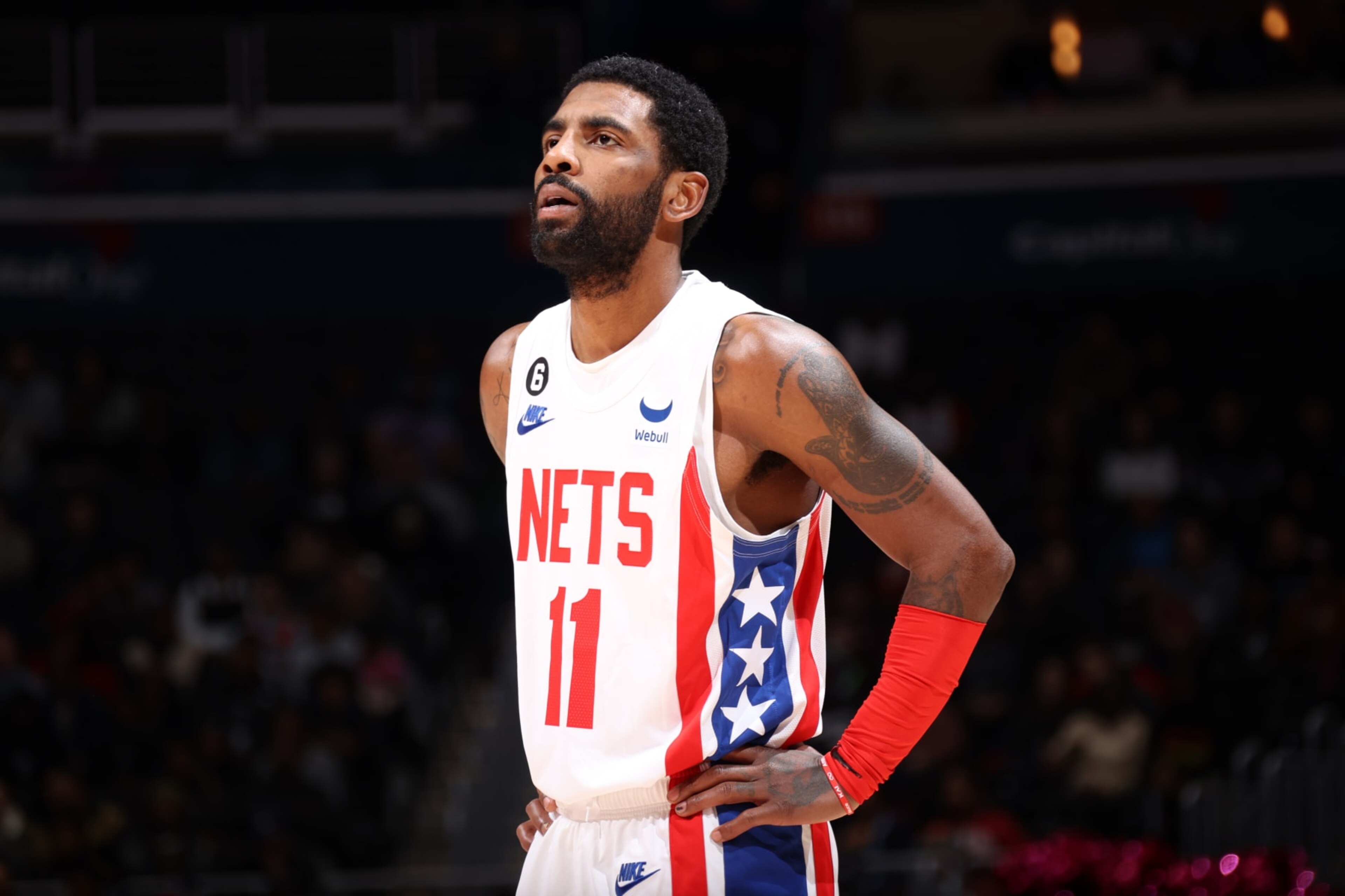 WASHINGTON, DC - DECEMBER 12: Kyrie Irving #11 of the Brooklyn Nets looks on during the game against the Washington Wizards on December 12, 2022 at Capital One Arena in Washington, DC. NOTE TO USER: User expressly acknowledges and agrees that, by downloading and or using this Photograph, user is consenting to the terms and conditions of the Getty Images License Agreement. Mandatory Copyright Notice: Copyright 2022 NBAE (Photo by Stephen Gosling/NBAE via Getty Images) WASHINGTON, DC - DECEMBER 12: Kyrie Irving #11 of the Brooklyn Nets looks on during the game against the Washington Wizards on December 12, 2022 at Capital One Arena in Washington, DC. NOTE TO USER: User expressly acknowledges and agrees that, by downloading and or using this Photograph, user is consenting to the terms and conditions of the Getty Images License Agreement. Mandatory Copyright Notice: Copyright 2022 NBAE (Photo by Stephen Gosling/NBAE via Getty Images)